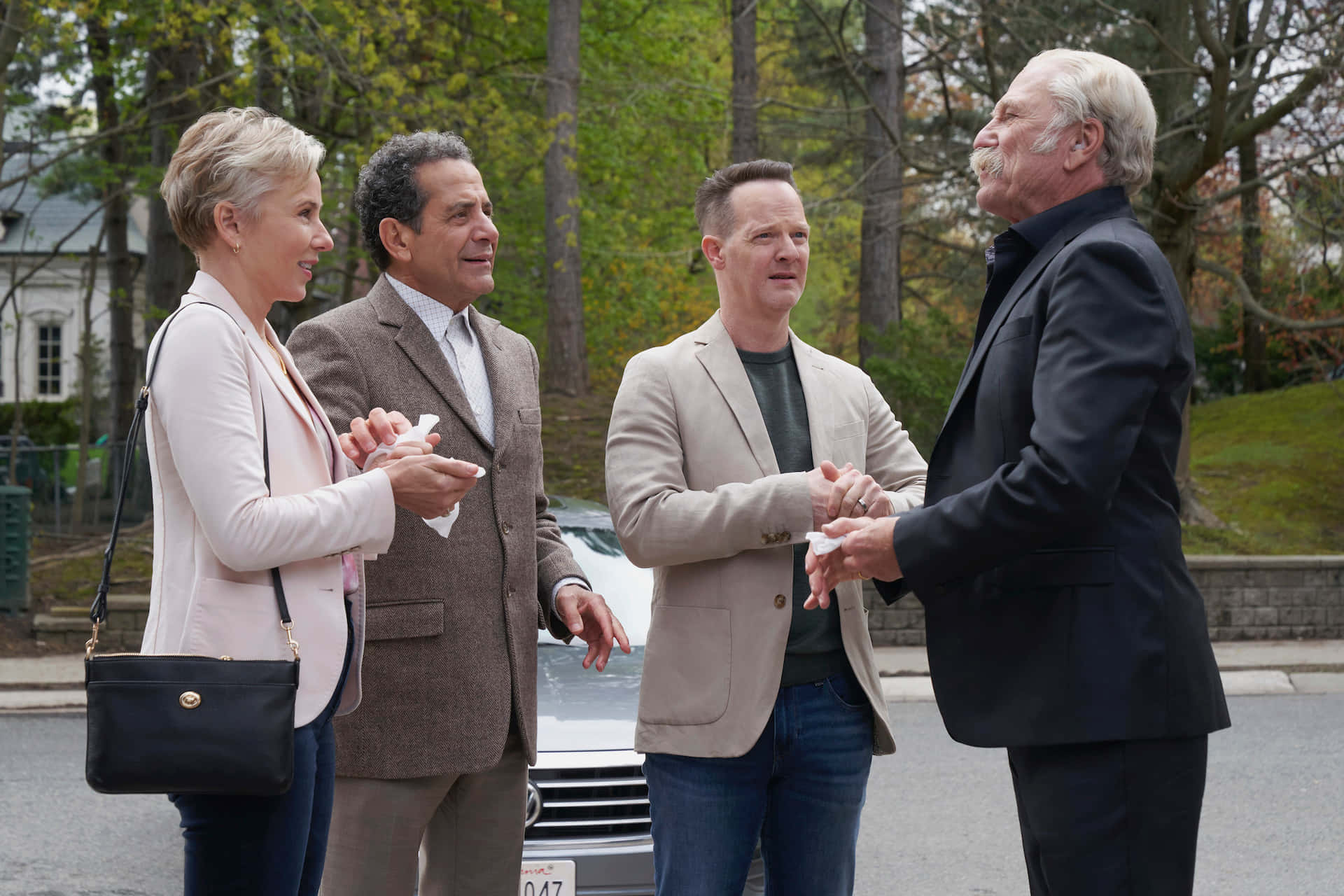 Groupof Four Outdoors Greeting Each Other