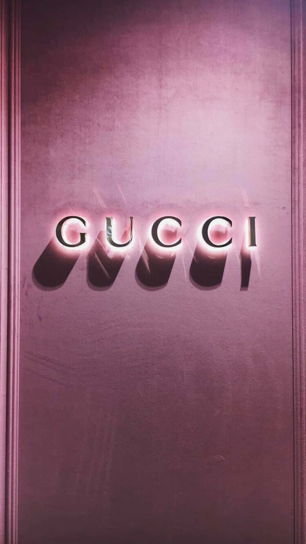 Gucci Logo On A Pink Wall