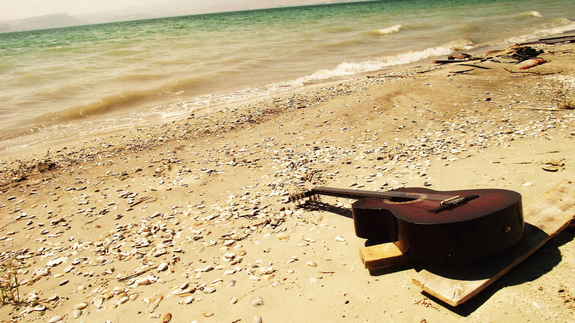 Guitar On Sunny Beach Background