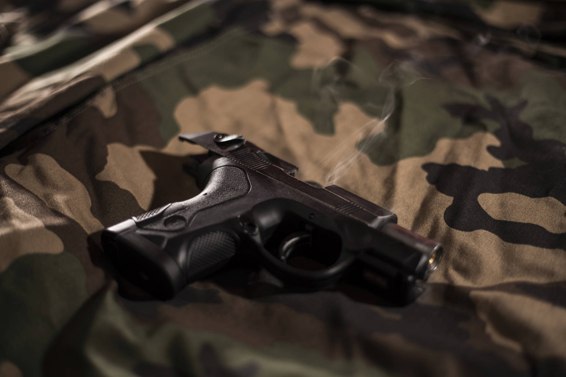 Gun On Camouflage Sheet Background