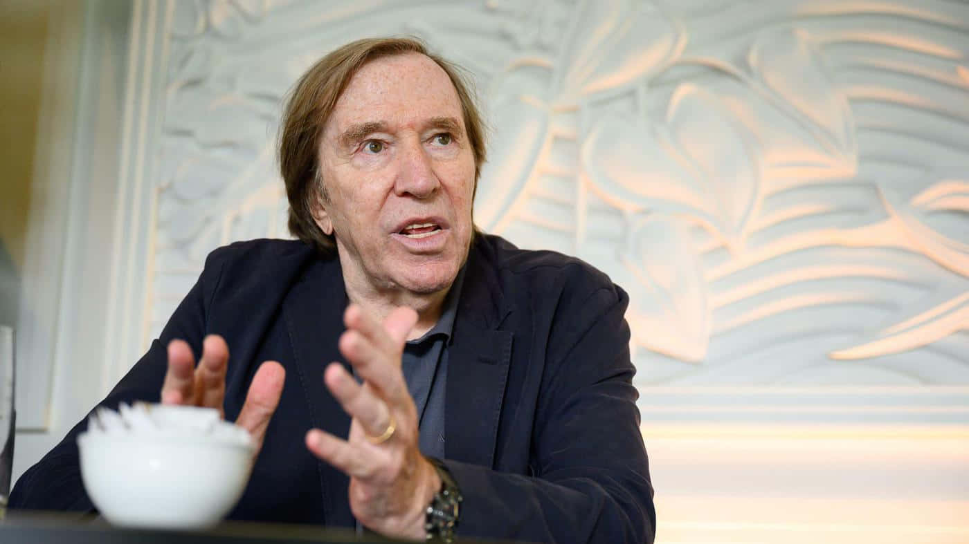 Gunter Netzer Discussing Football Background