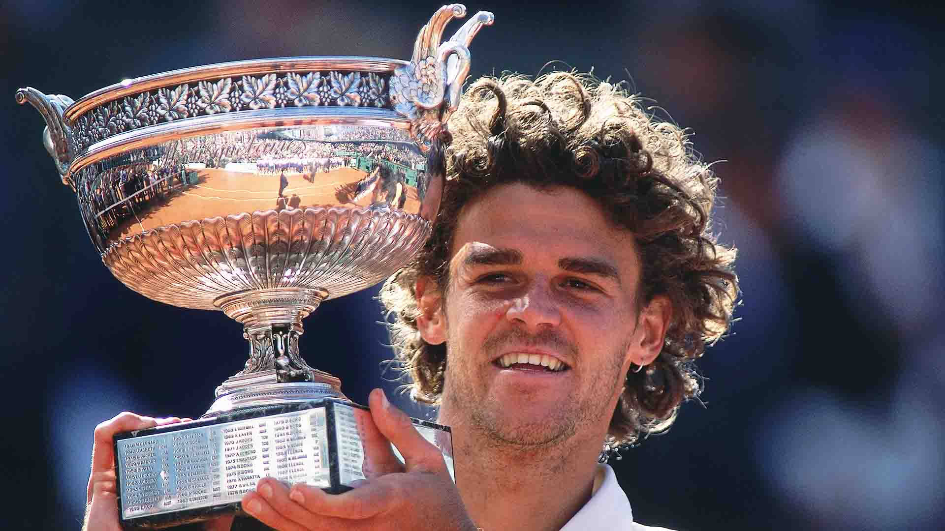 Gustavo Kuerten Carrying His Trophy Background