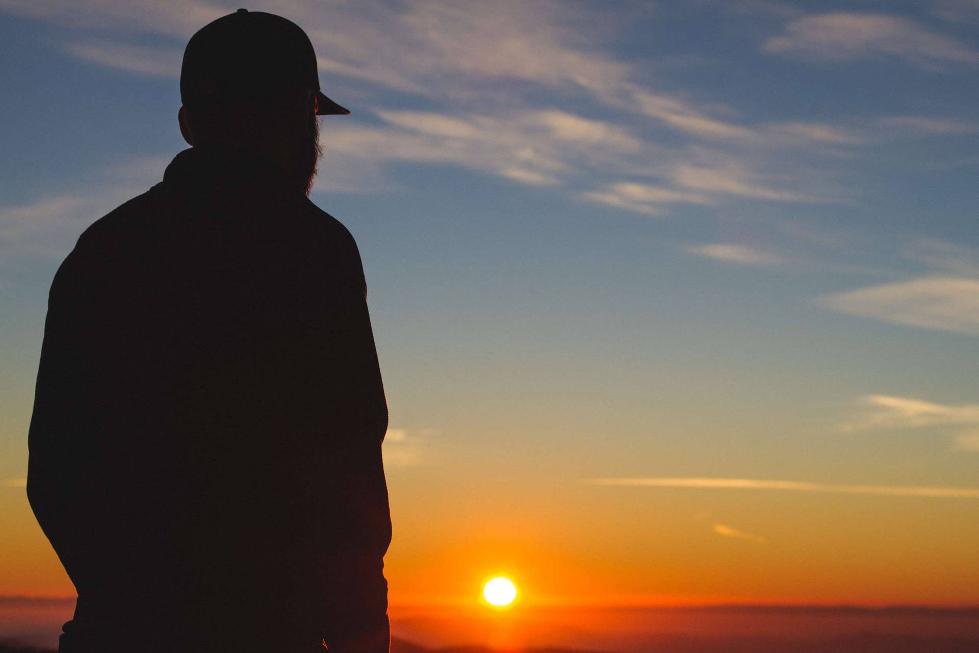 Guy Silhouette At Sunset On The Horizon Background