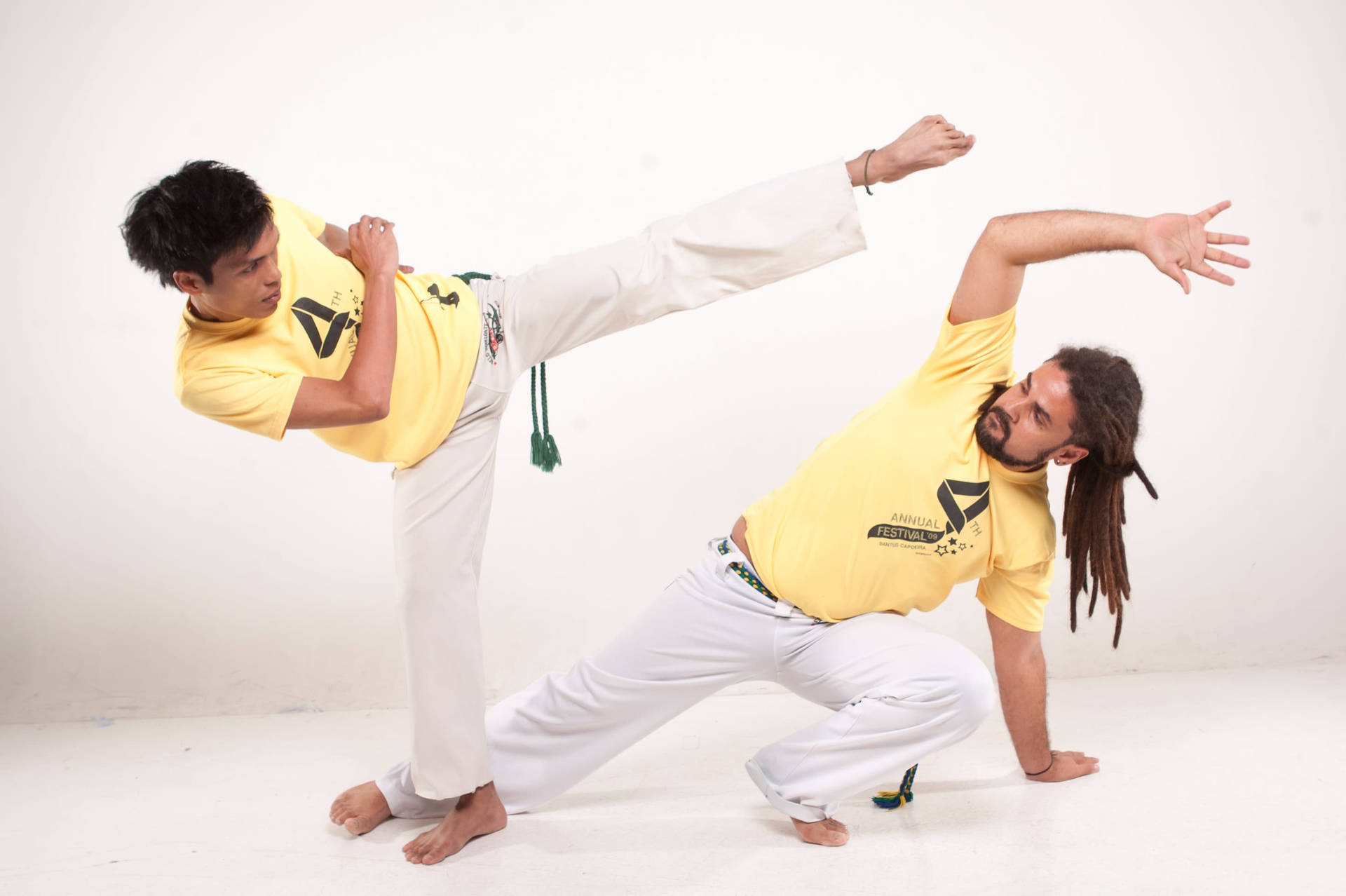 Guys In Yellow Shirts Doing Capoeira Background