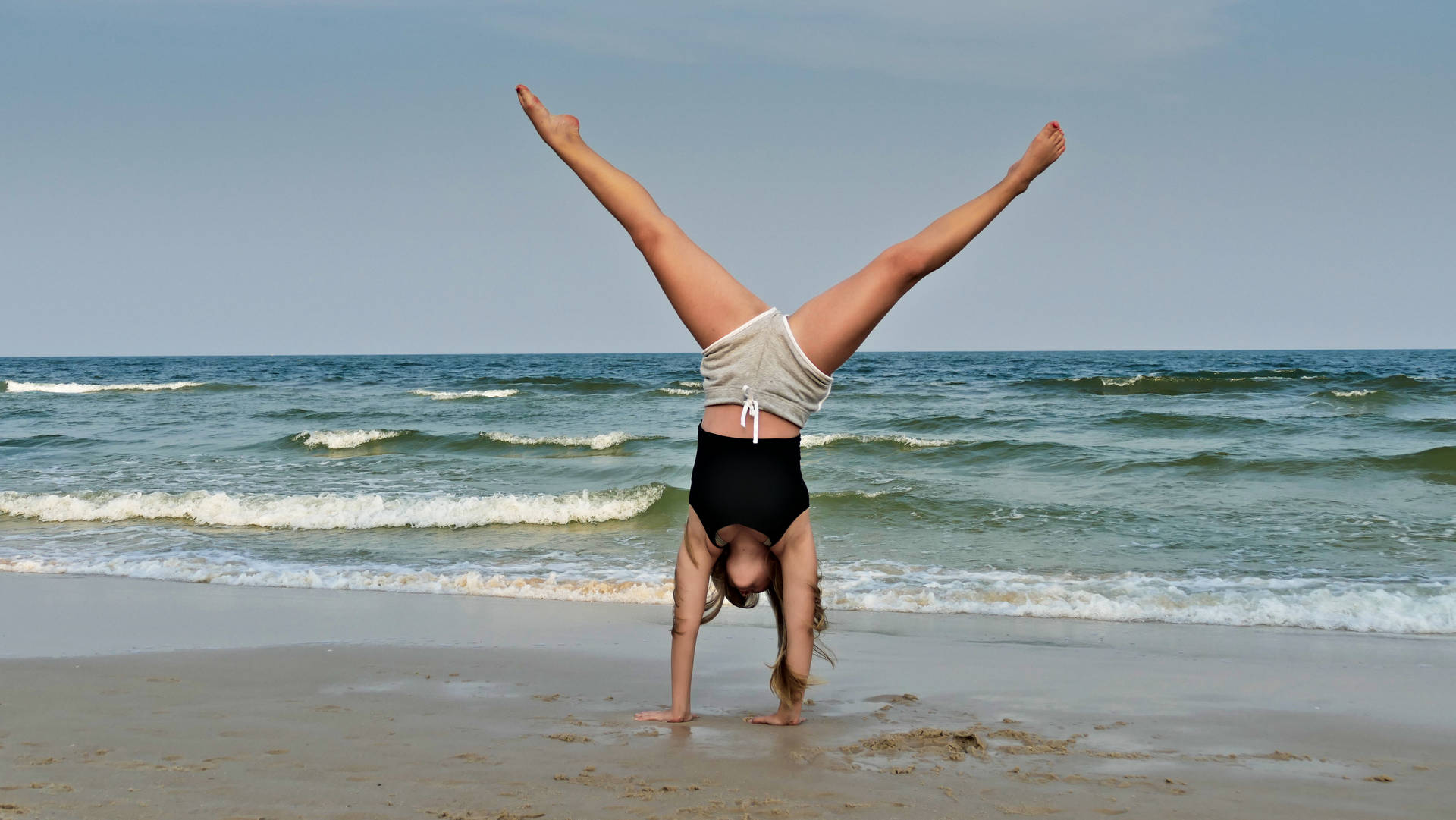 Gymnastics Handstand At Seashore Background