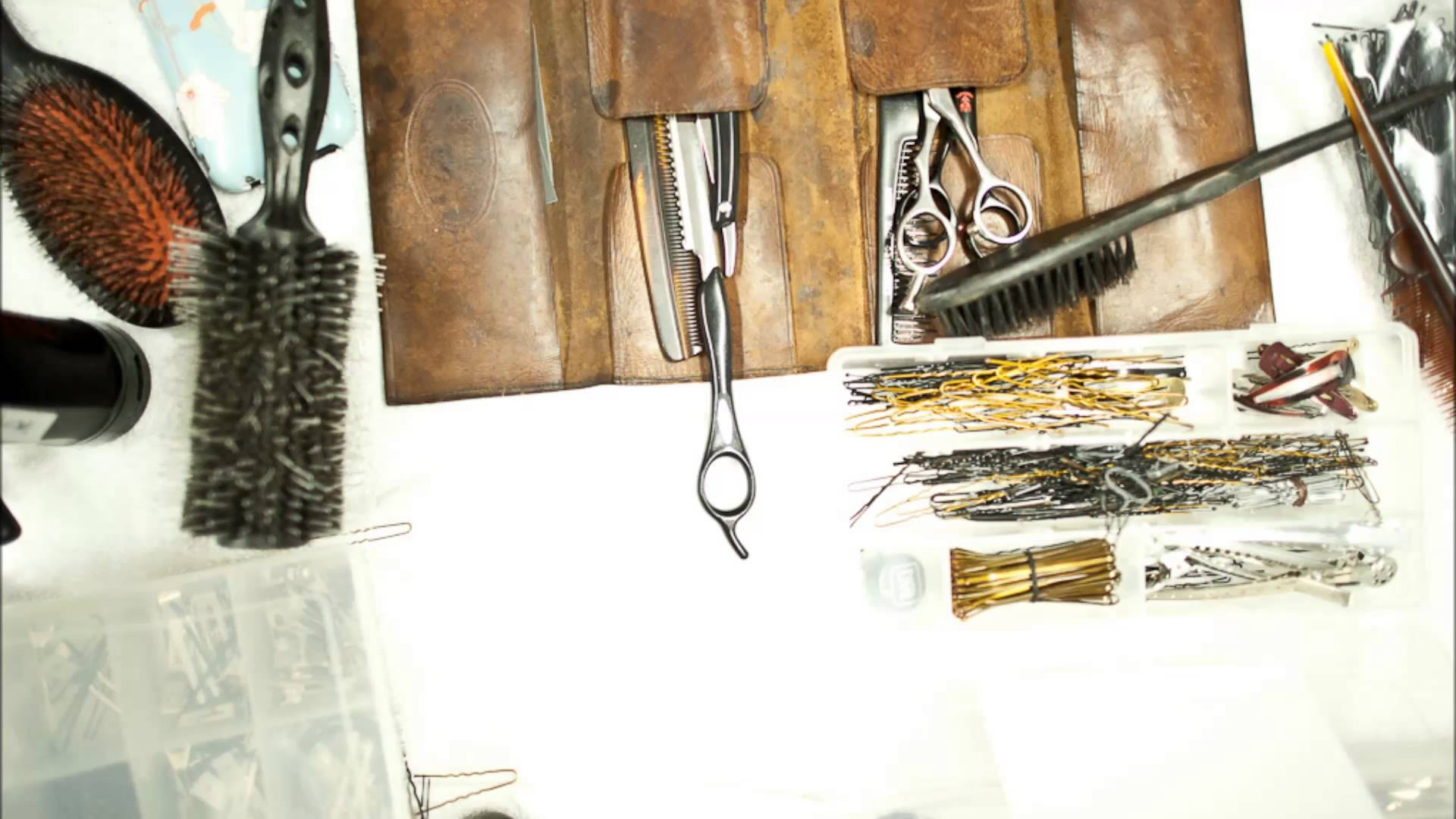 Haircut Tools In Leather Bag Background