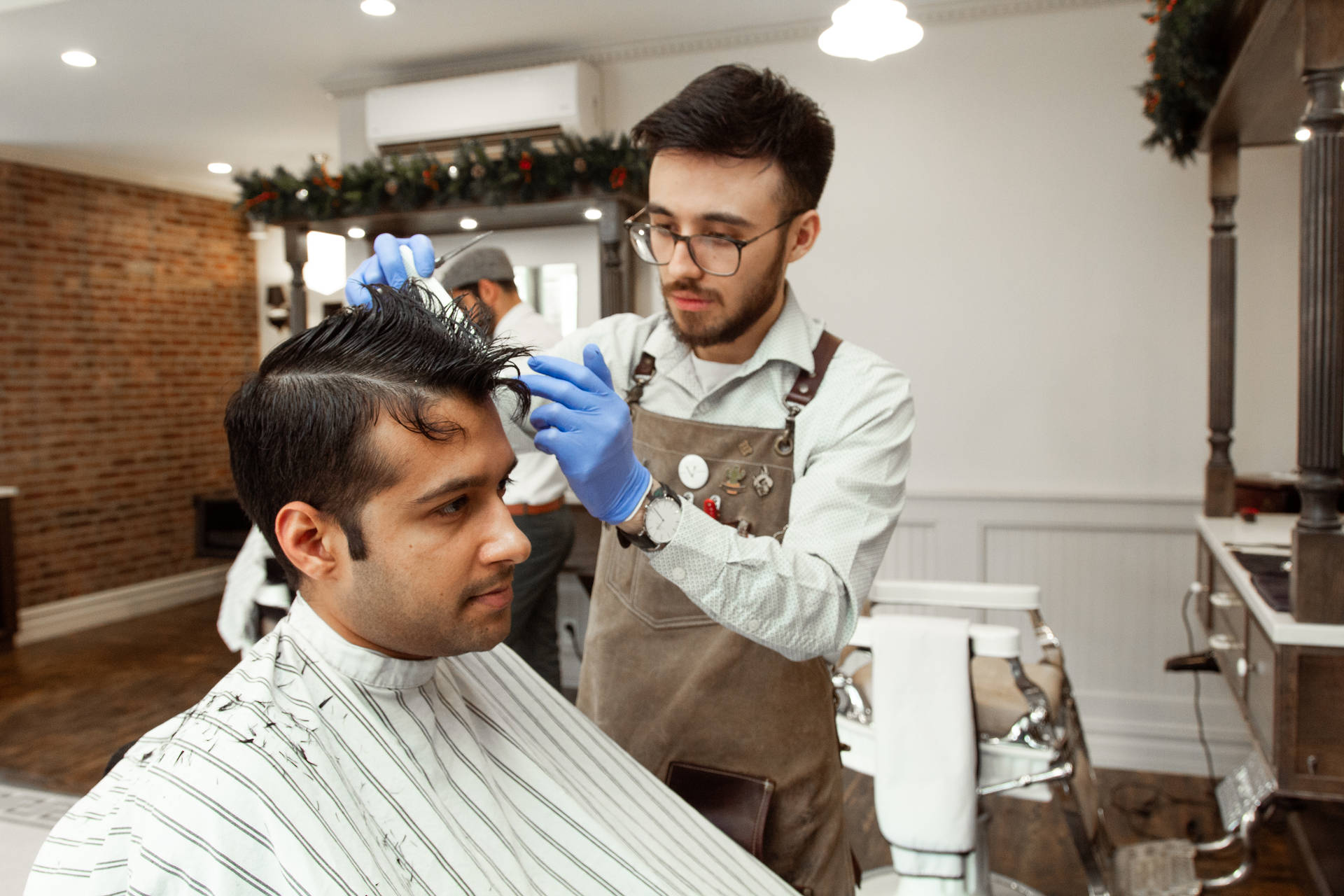 Hairdresser With Apron Performing Haircut Background