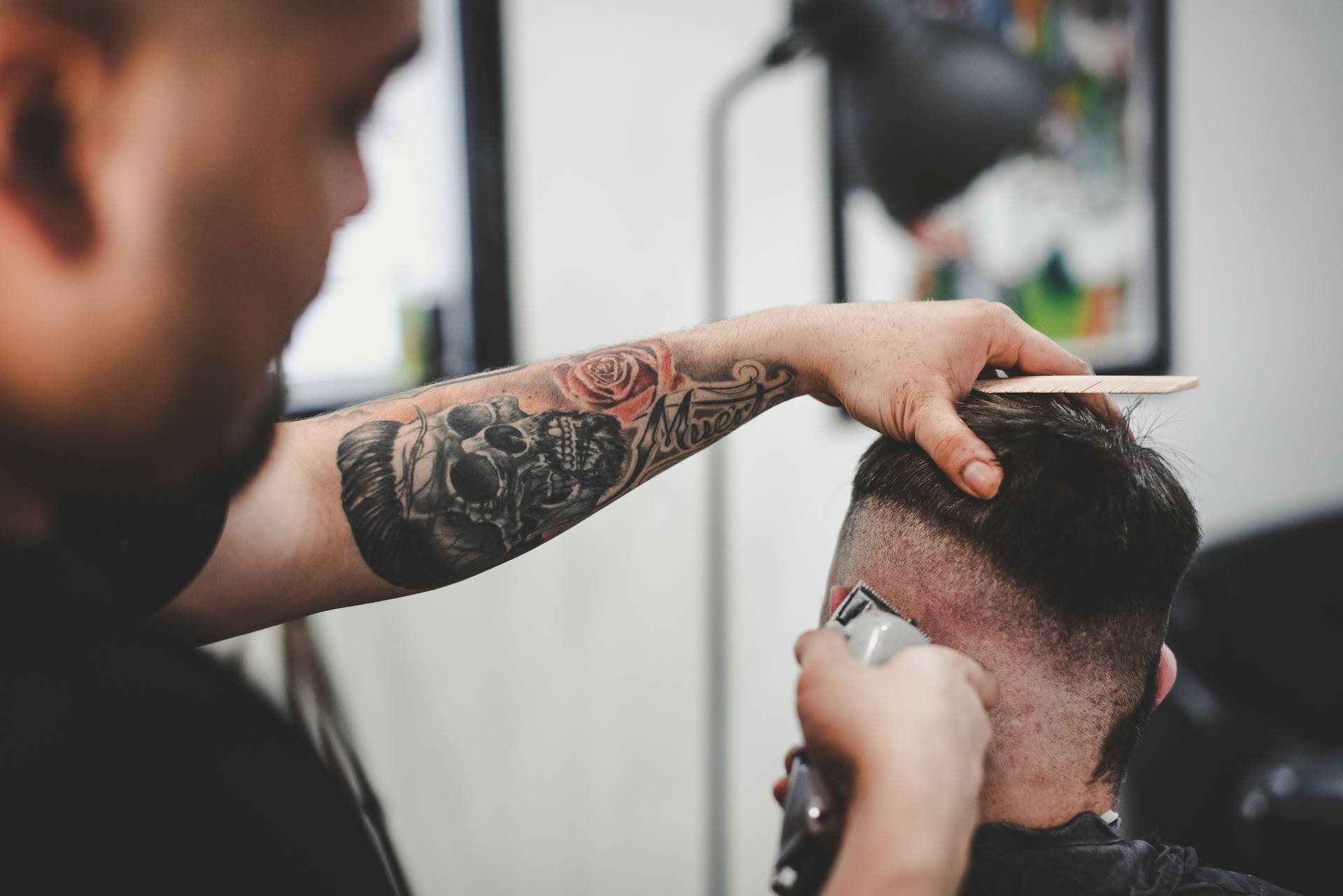 Hairdresser With Tattoo Doing Haircut Background