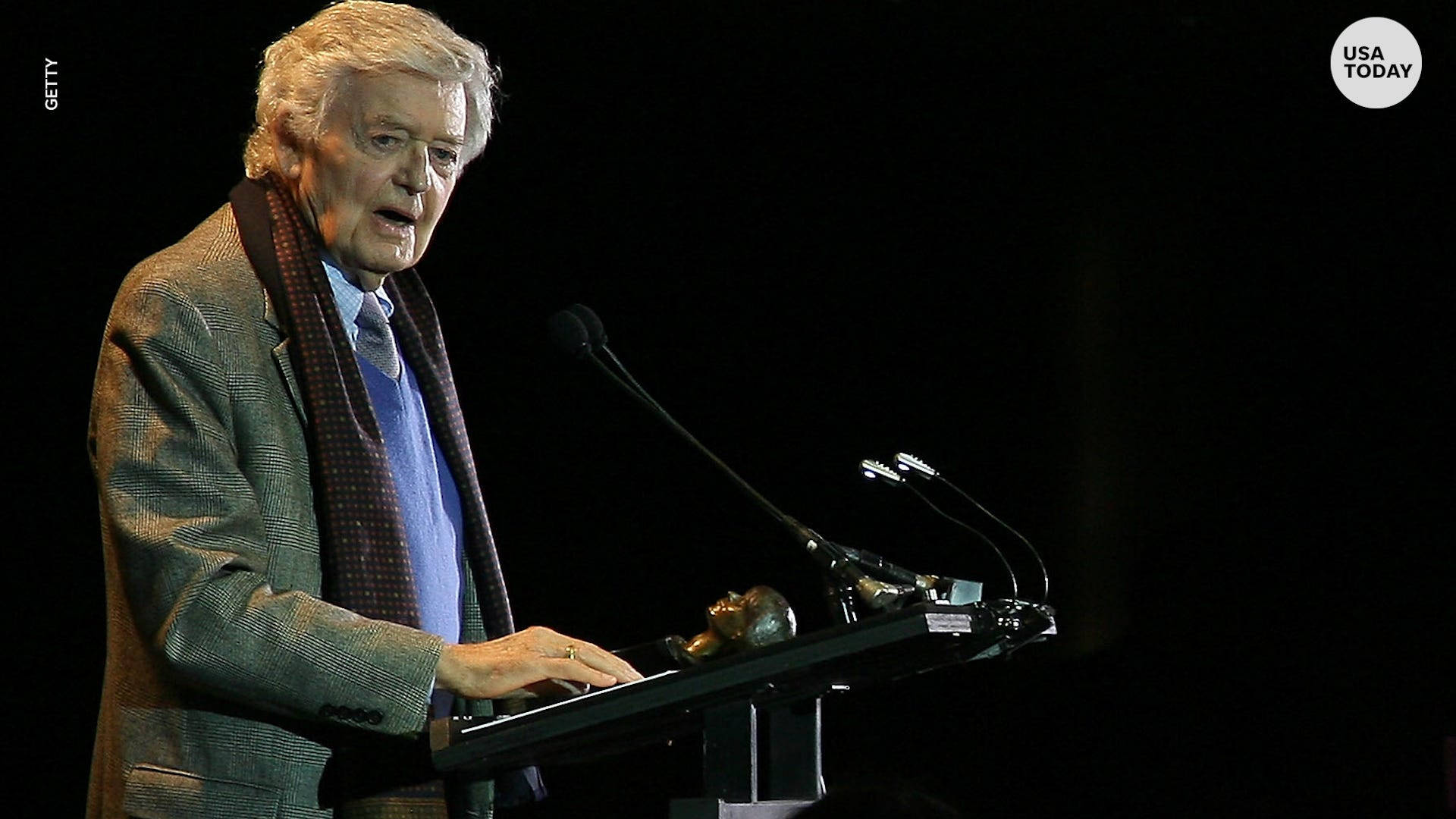 Hal Holbrook Speaking On Stage Background