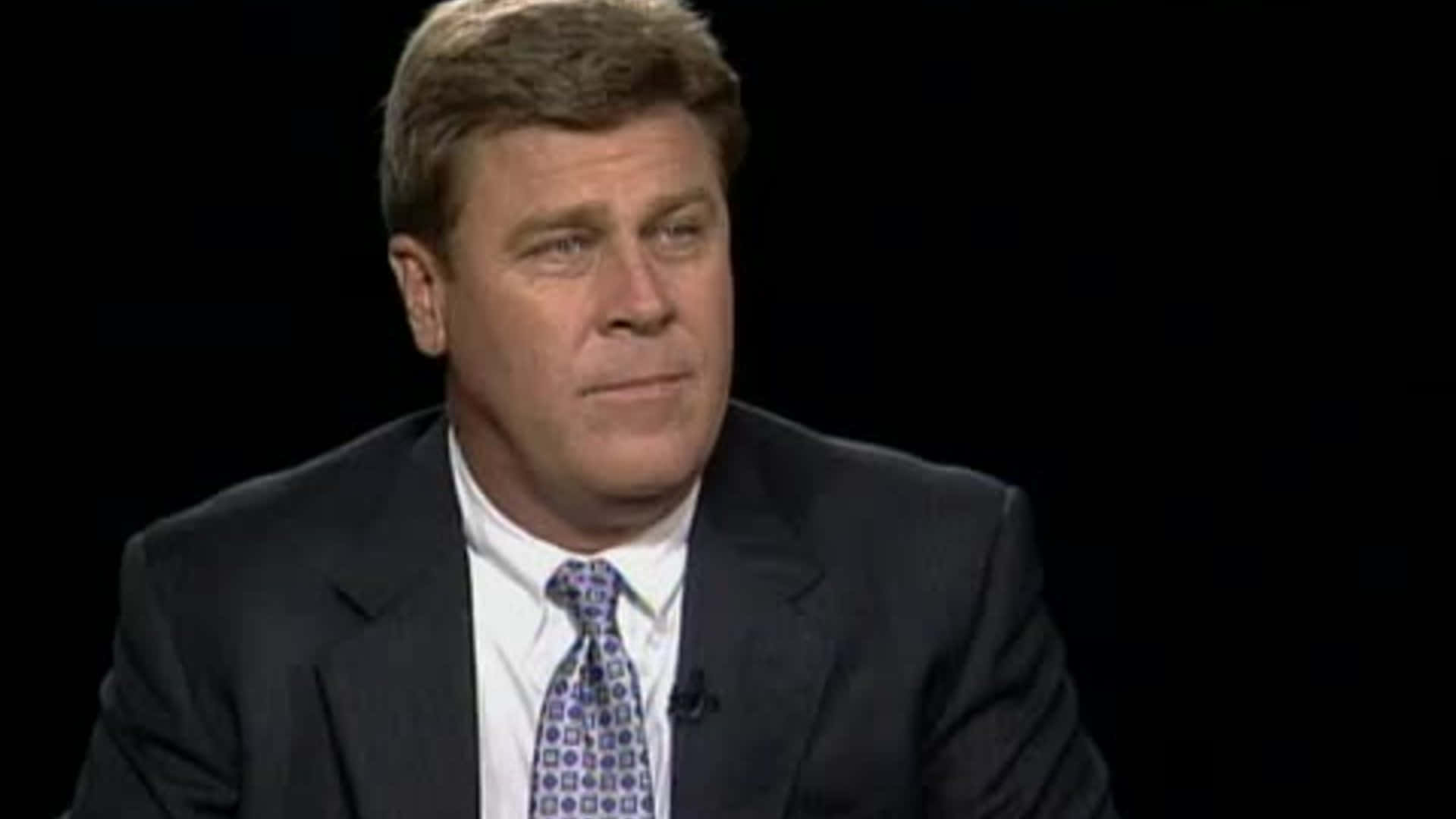 Hal Sutton Wearing A Suit Background