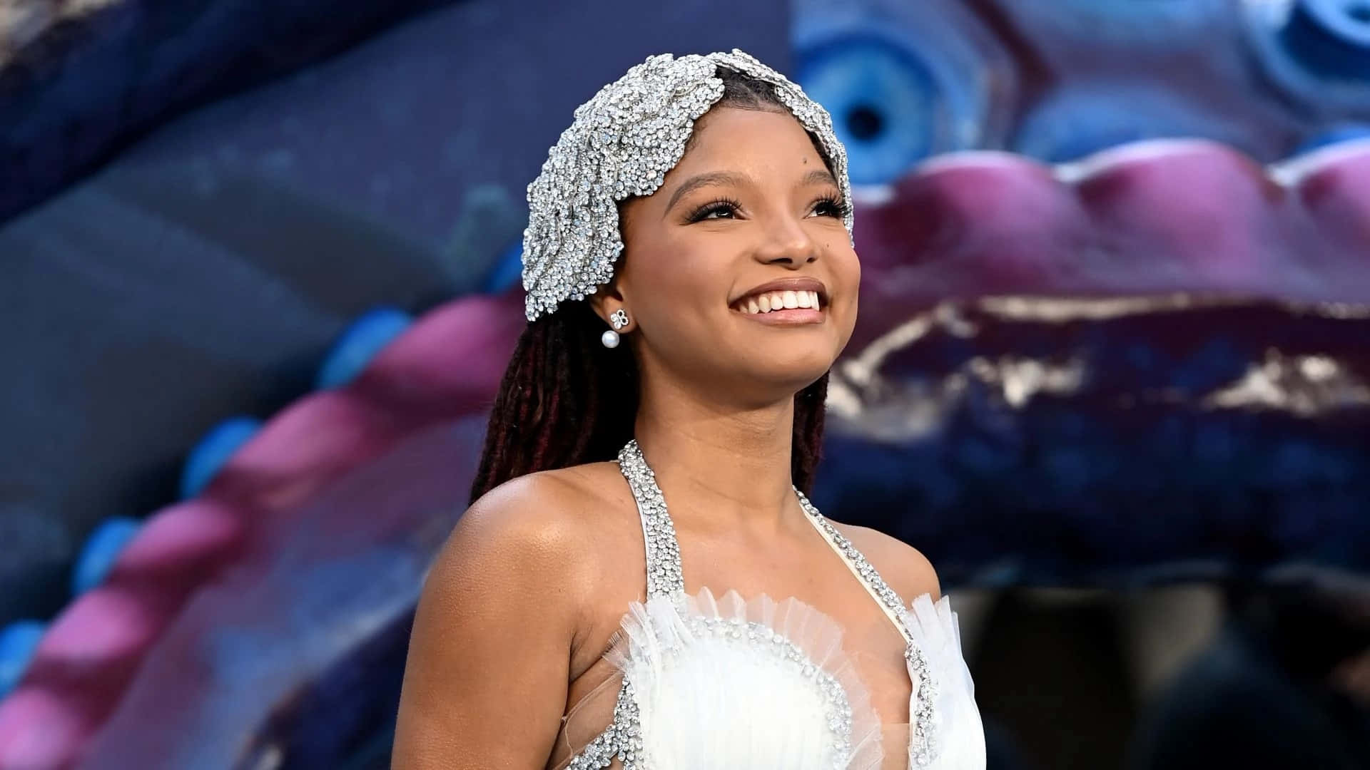 Halle Bailey Smilingwith Headpiece Background