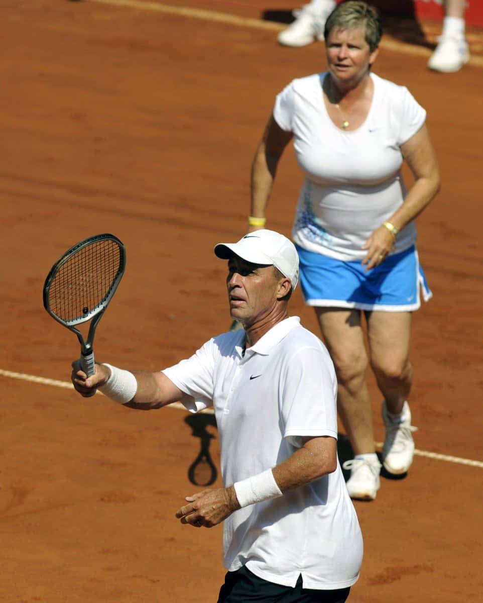 Hana Mandlikova Playing Tennis Together With Another Player Background