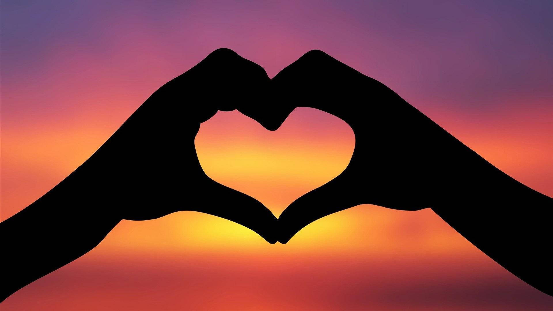 Hand Heart Silhouette In The Sunset Background
