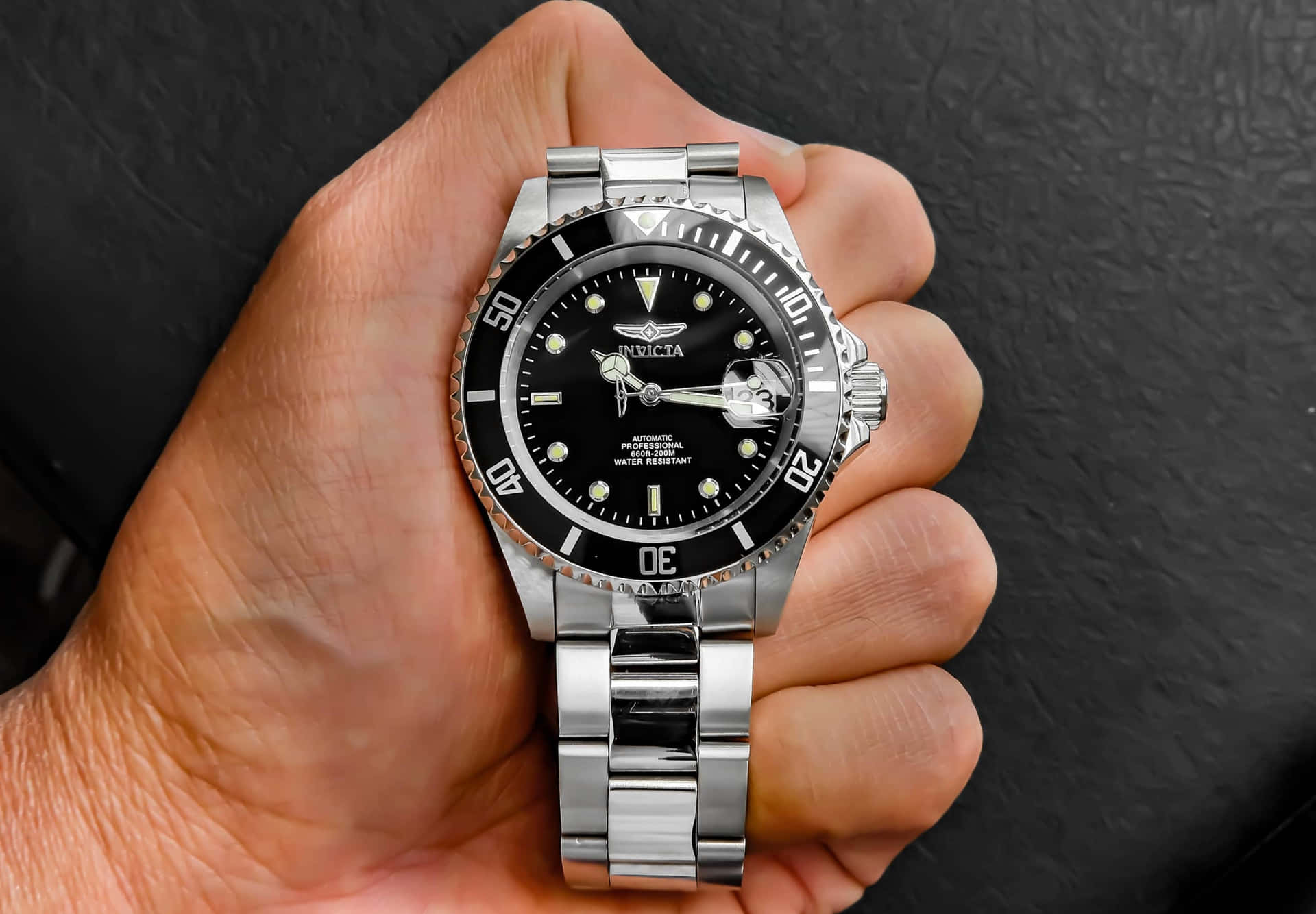 Hand Holding Automatic Silver Watch Background