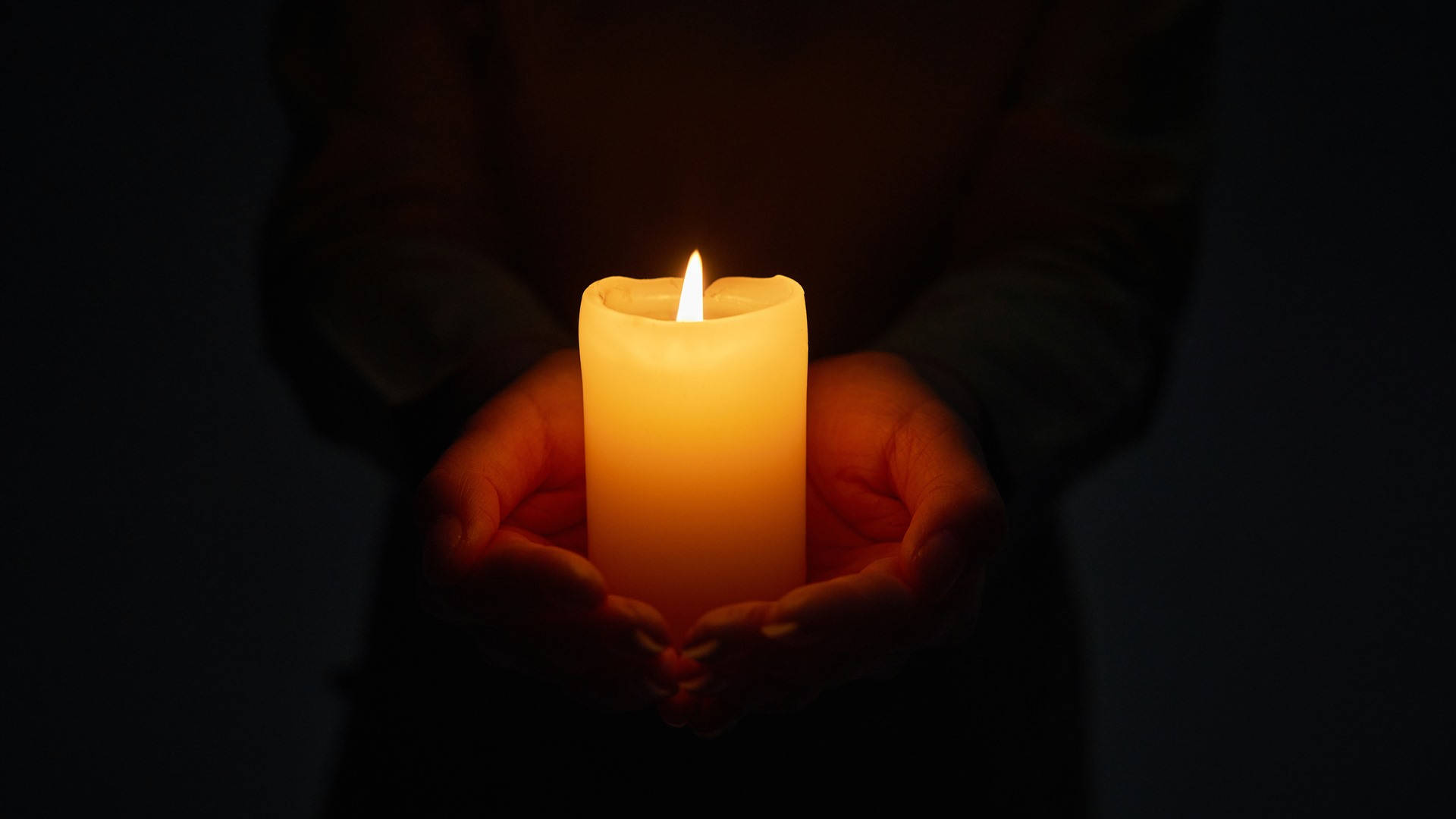 Hand Holding Condolence Candle Background