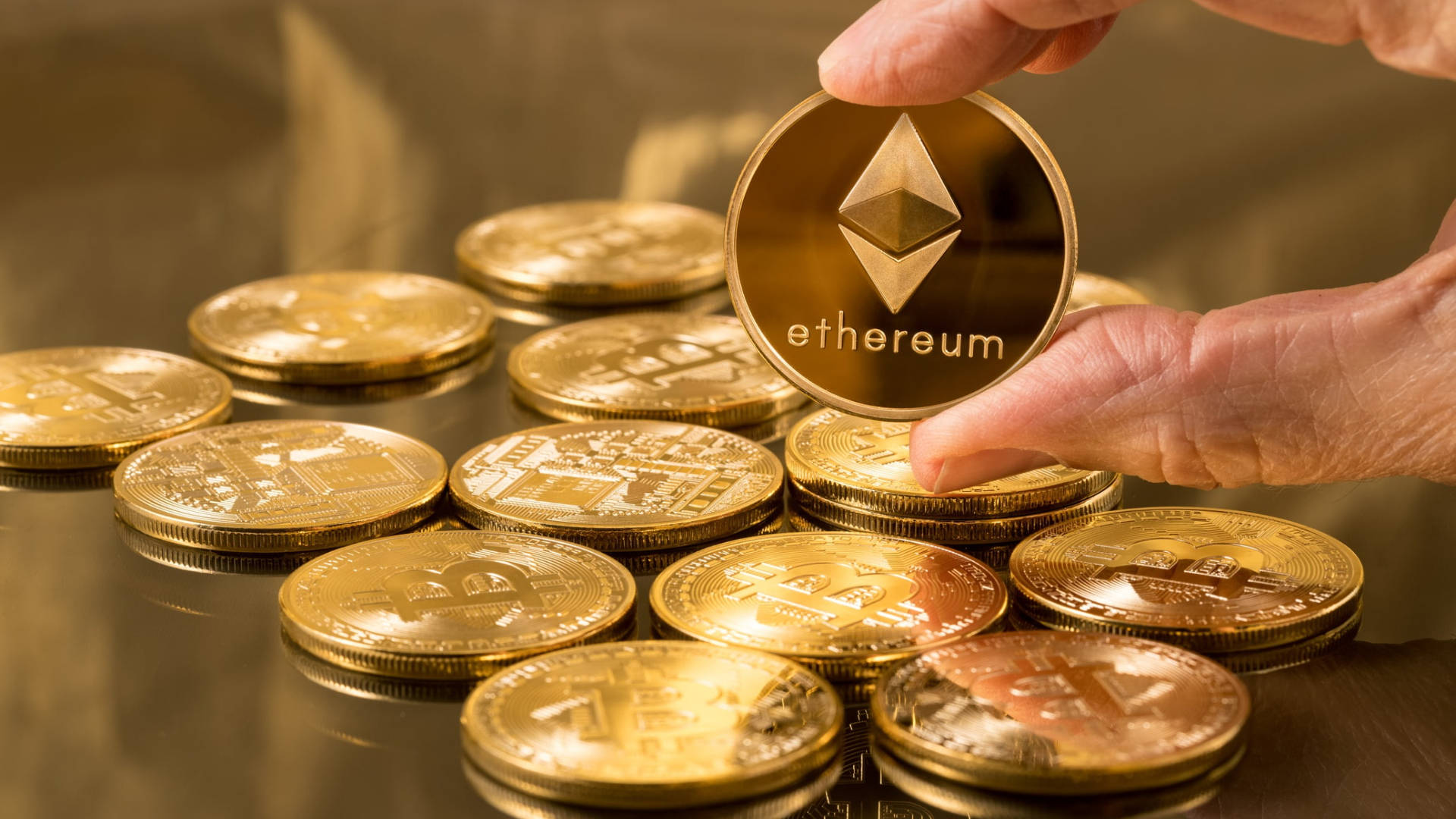 Hand Holding Ethereum Gold Coin Background