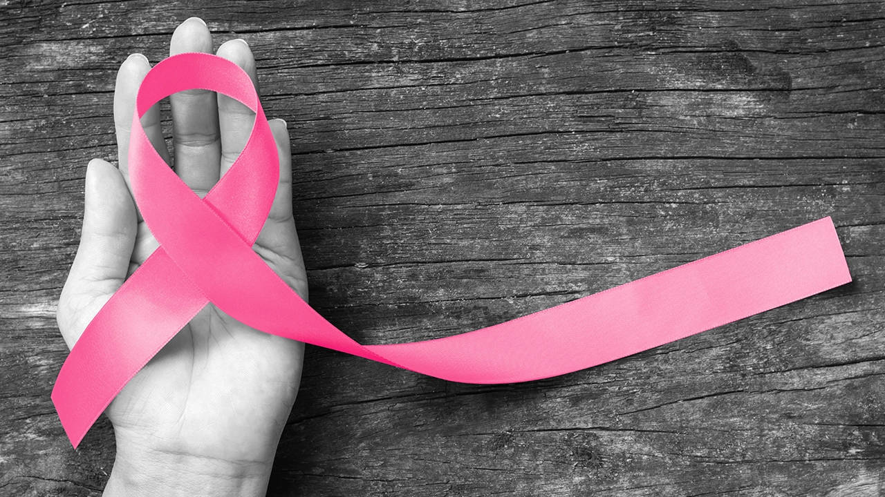 Hand Holding Ribbon Breast Cancer Awareness Background