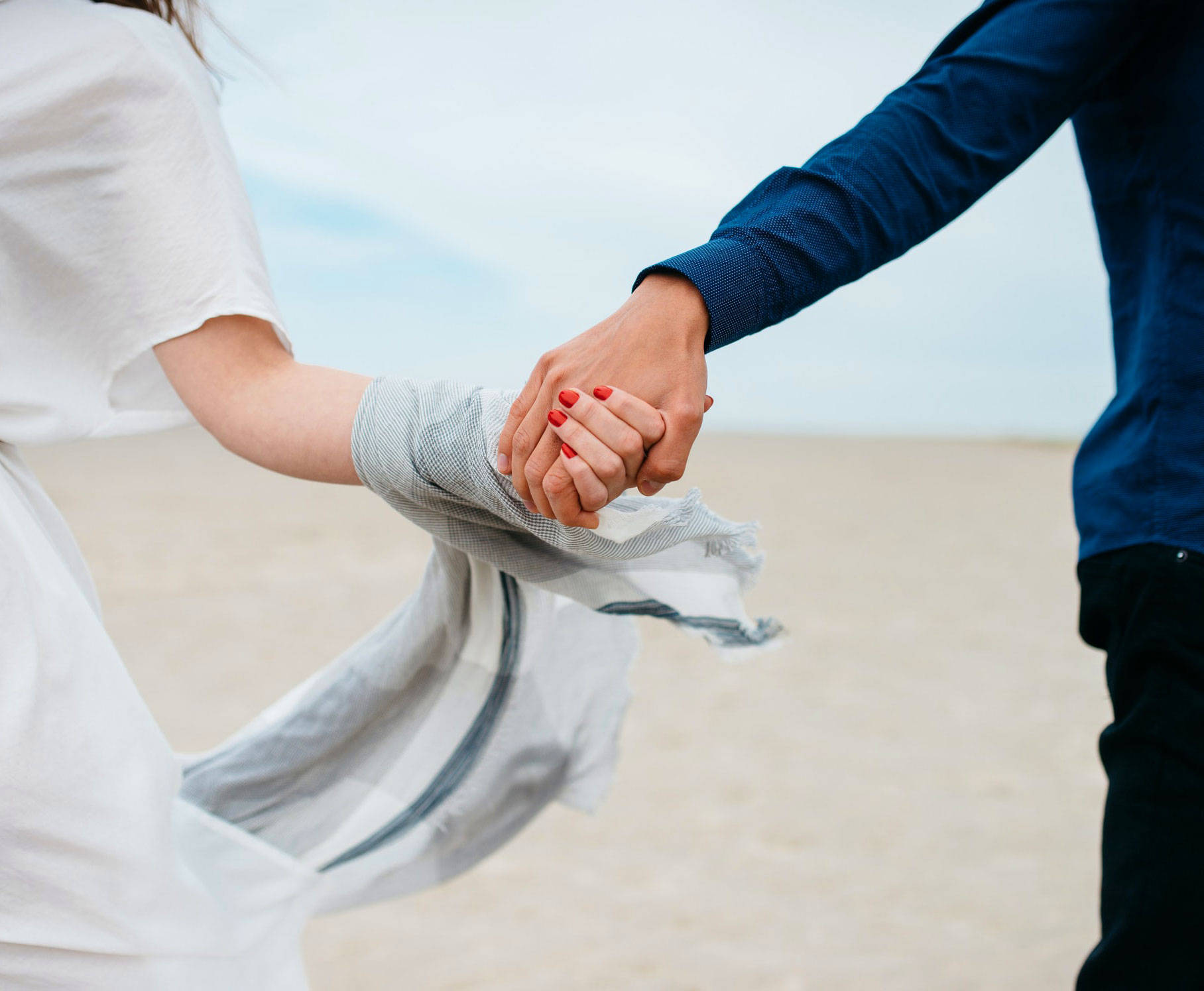 Hand In Hand Couple At The Beach Background