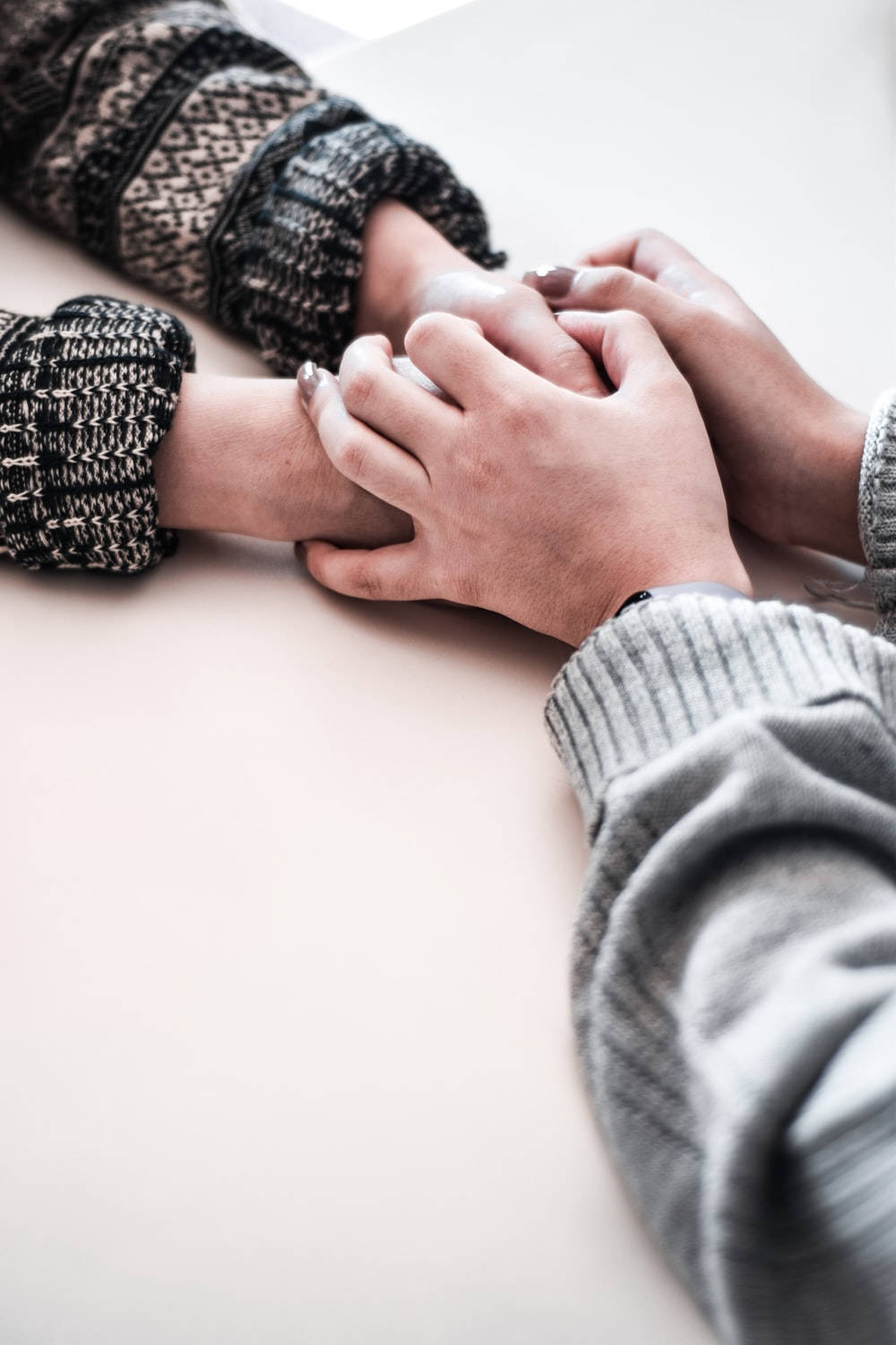 Hand In Hand On White Table