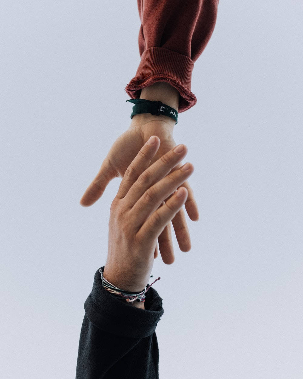 Hand In Hand Reaching Upwards Background