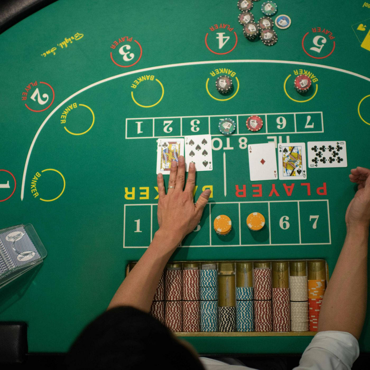 Hand Of The Dealer In A Baccarat Game Background