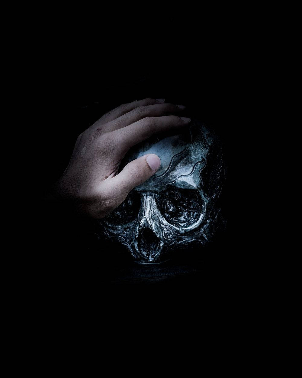 Hand On Skull Black Horror Background