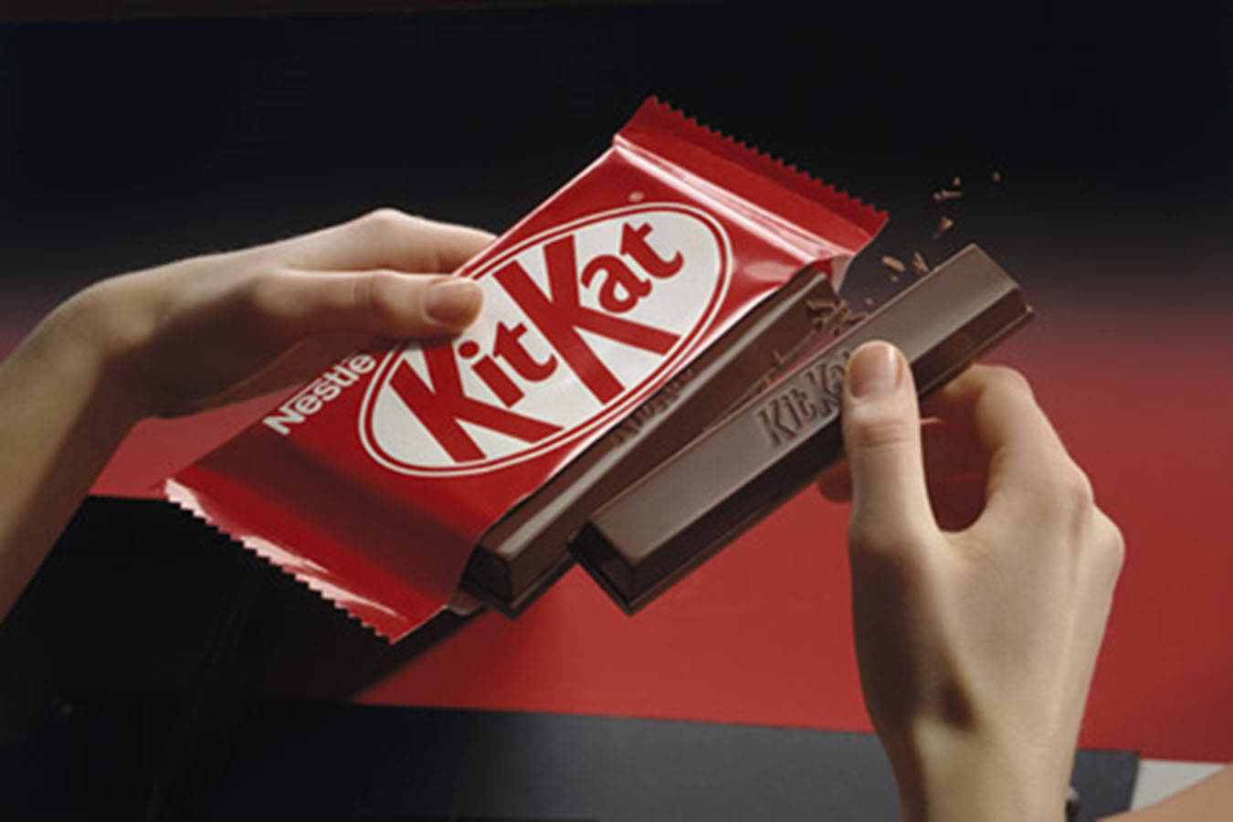 Hands Breaking Kit Kat Background