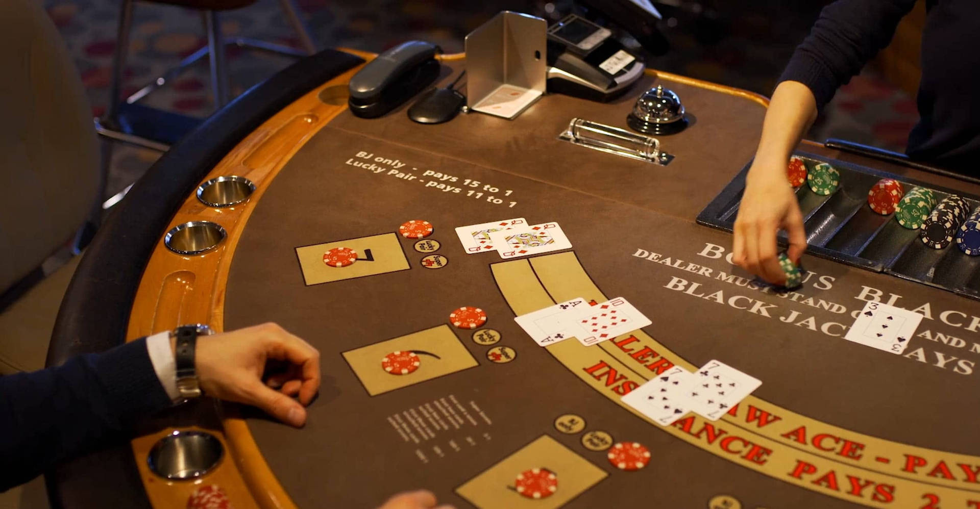 Hands Of The Players Brown Table Playing Baccarat Background