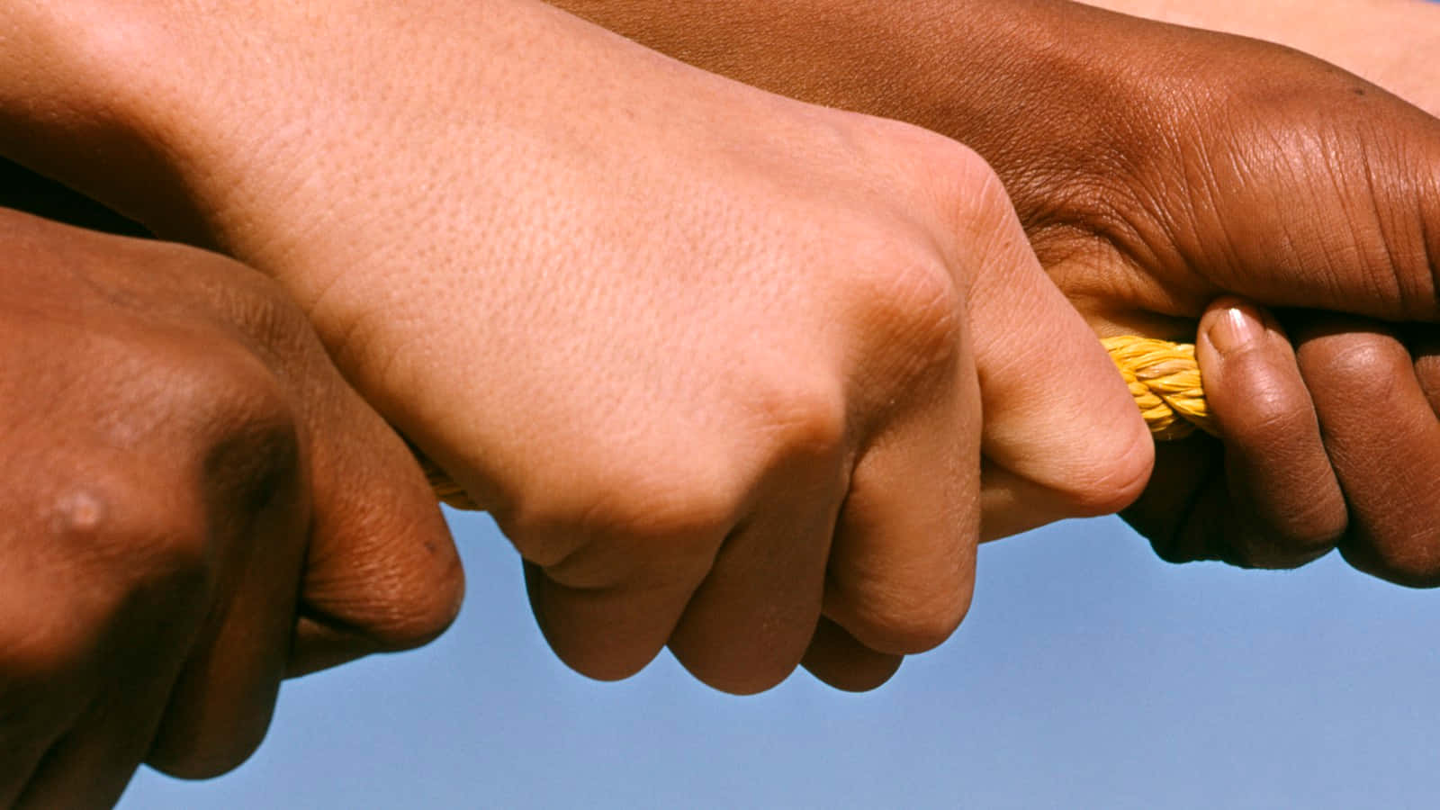 Hands Pulling Rope Symbolizing Anti Racism Background