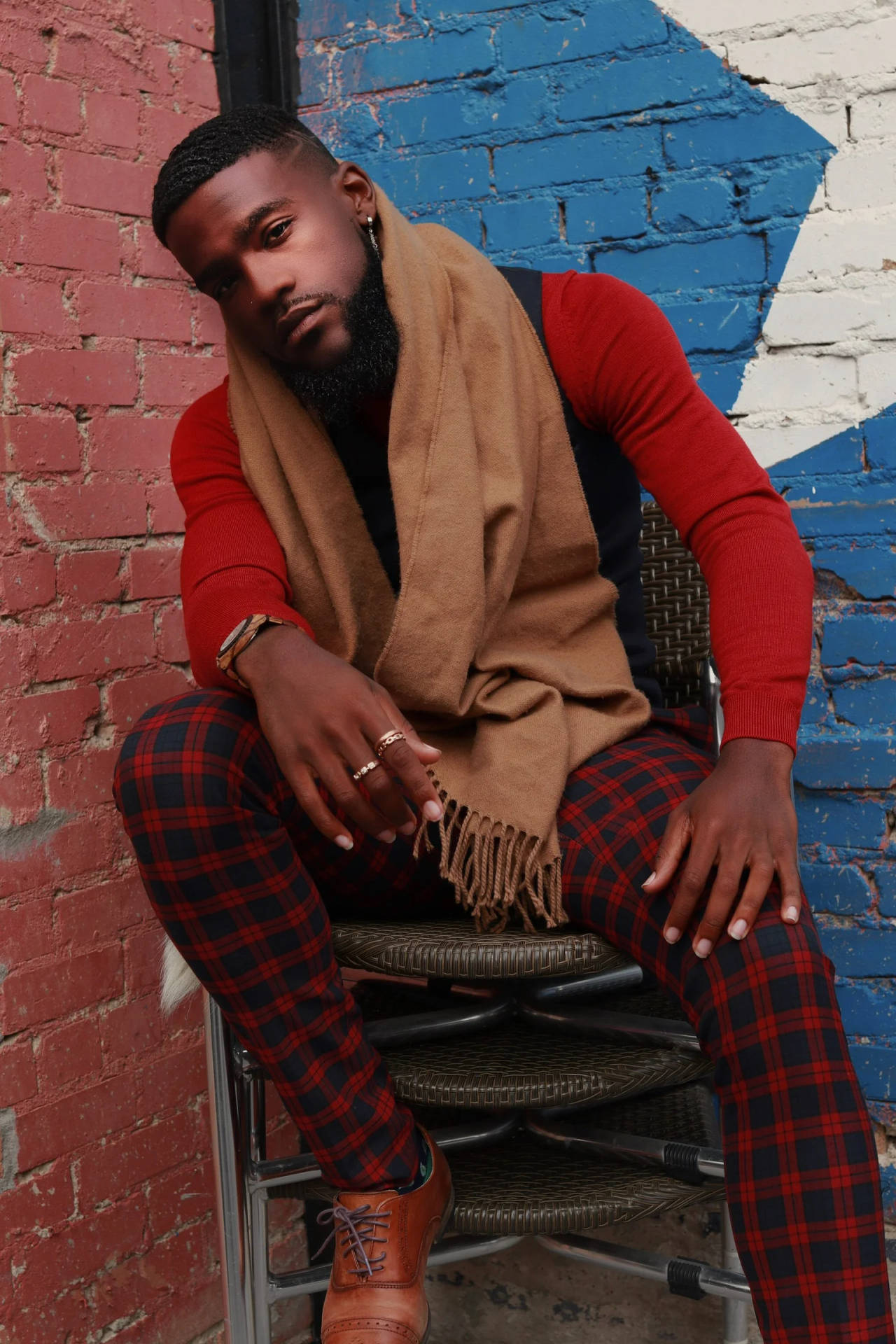 Handsome Black Man In Checkered Pants Posing With Confidence Background