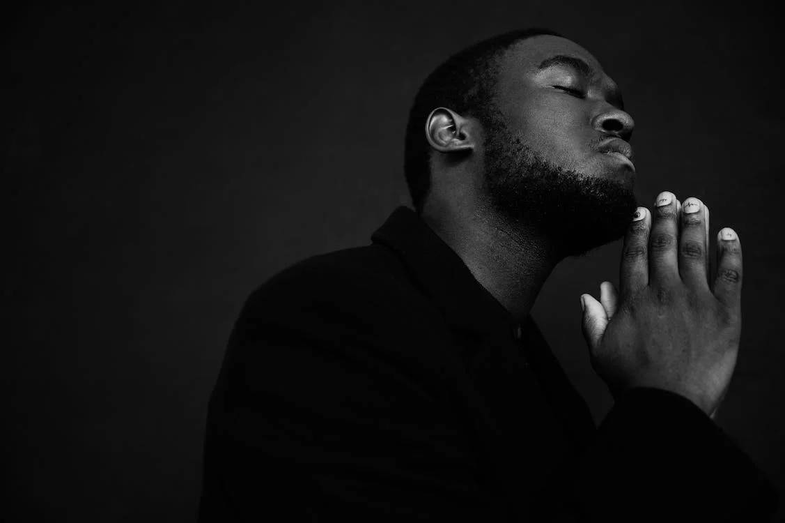 Handsome Black Man Prayer Gesture Background