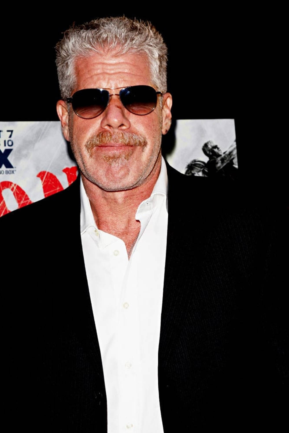 Handsome Ron Perlman In A Suit Background