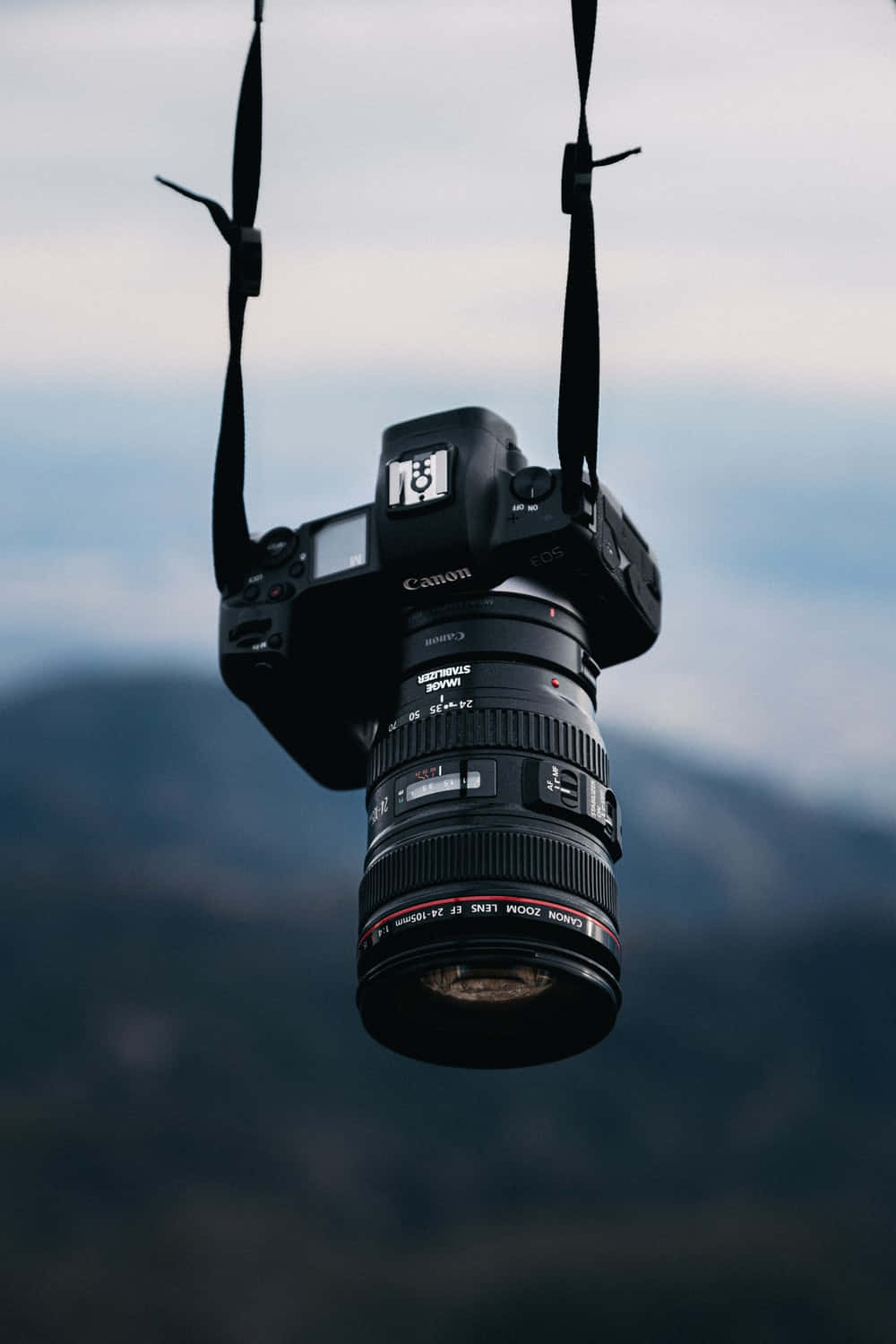 Hanging Photography Camera Against Mountain Background