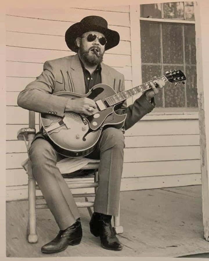 Hank Williams Jr Performing For A Crowd Background