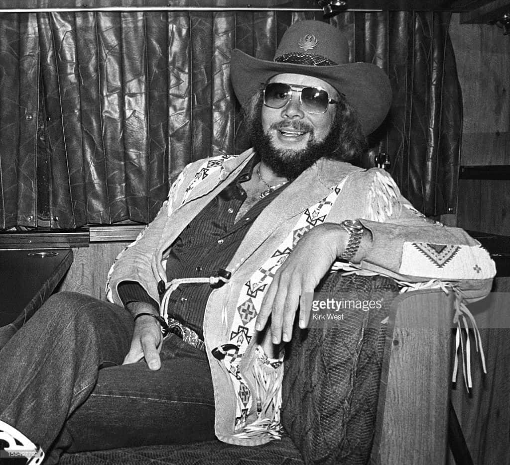 Hank Williams Jr. Strumming A Guitar On-stage Background