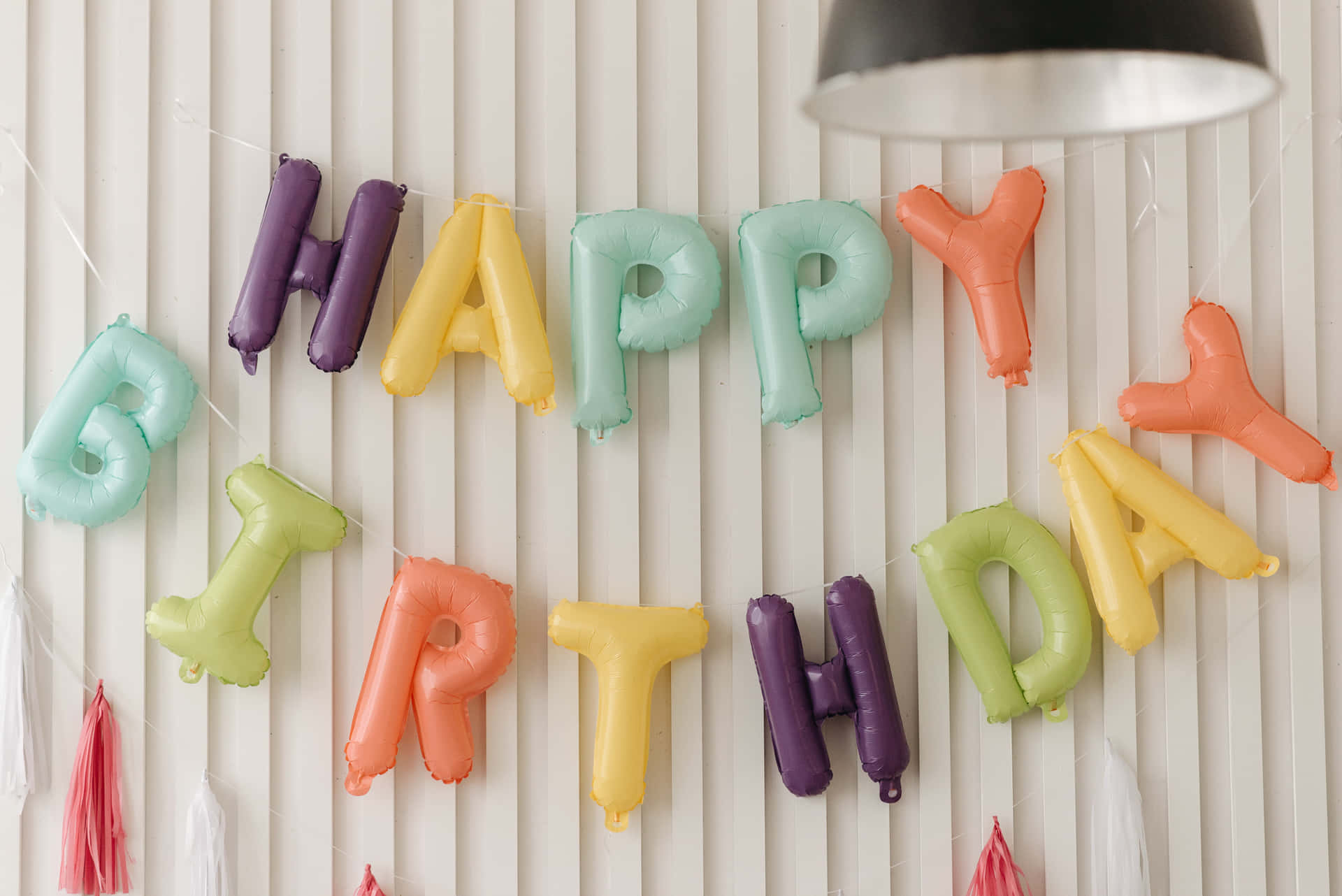Happy Birthday Balloons Hanging On A Wall Background