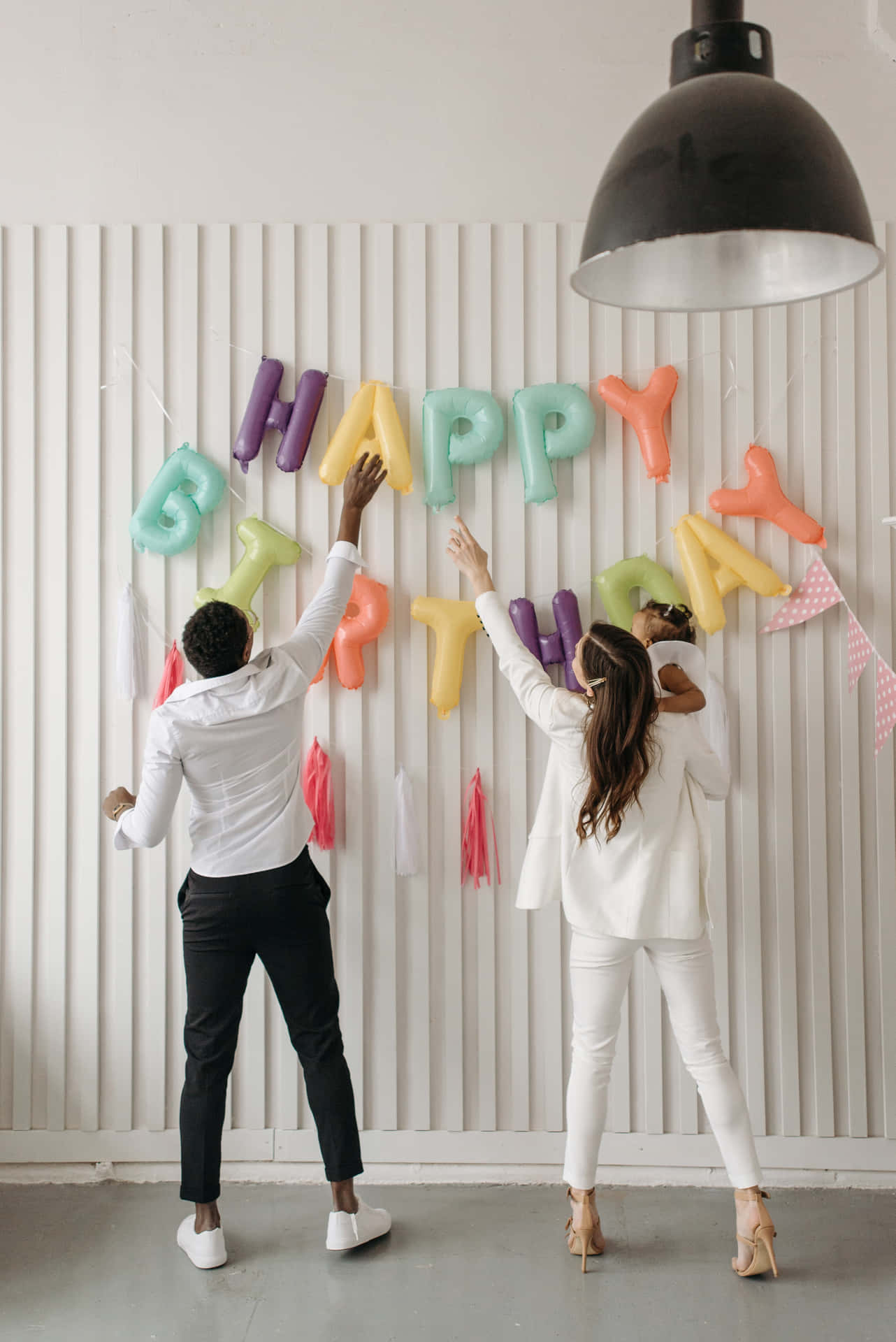 Happy Birthday Party - A Couple Of People In White Standing In Front Of A Happy Birthday Banner Background