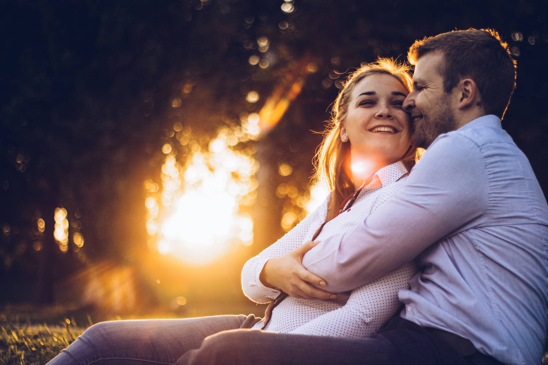 Happy Couple Hugging With Sunbeam Background