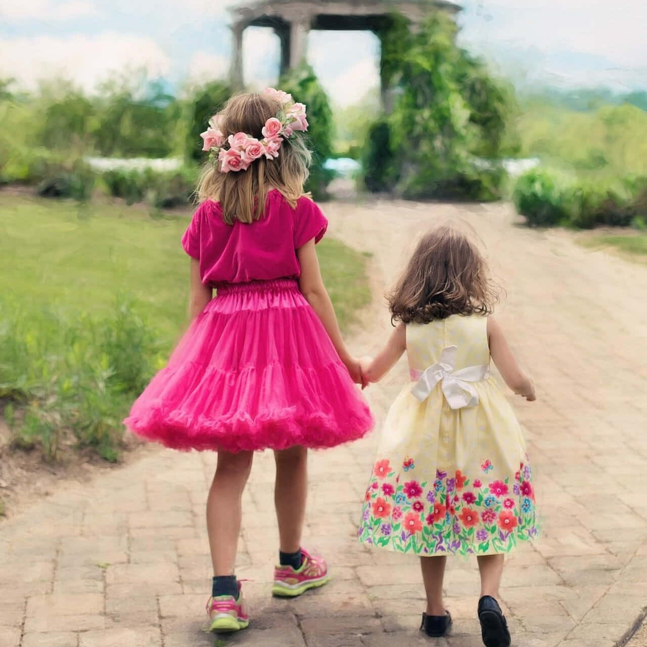 Happy Cute Sisters Holding Hands While Walking