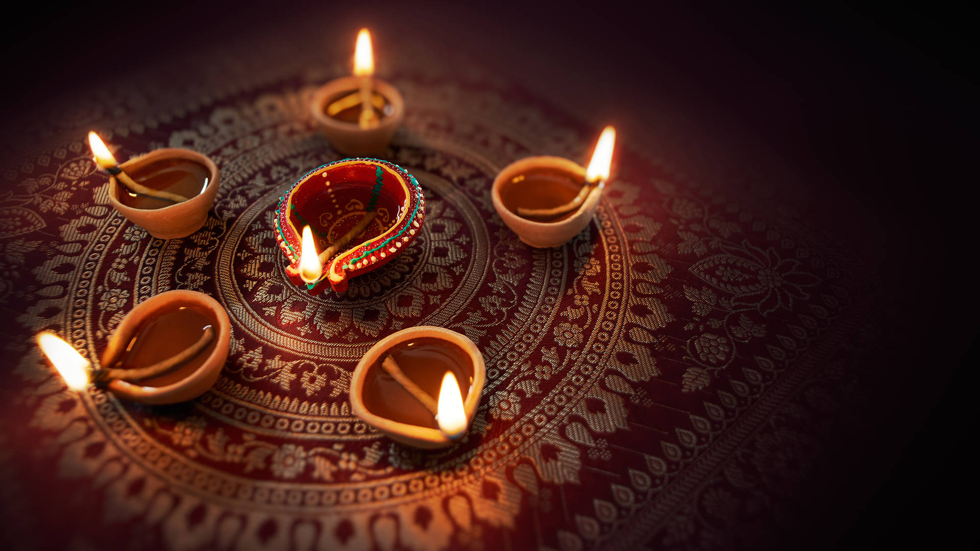 Happy Diwali Oil Lamps On Carpet Background