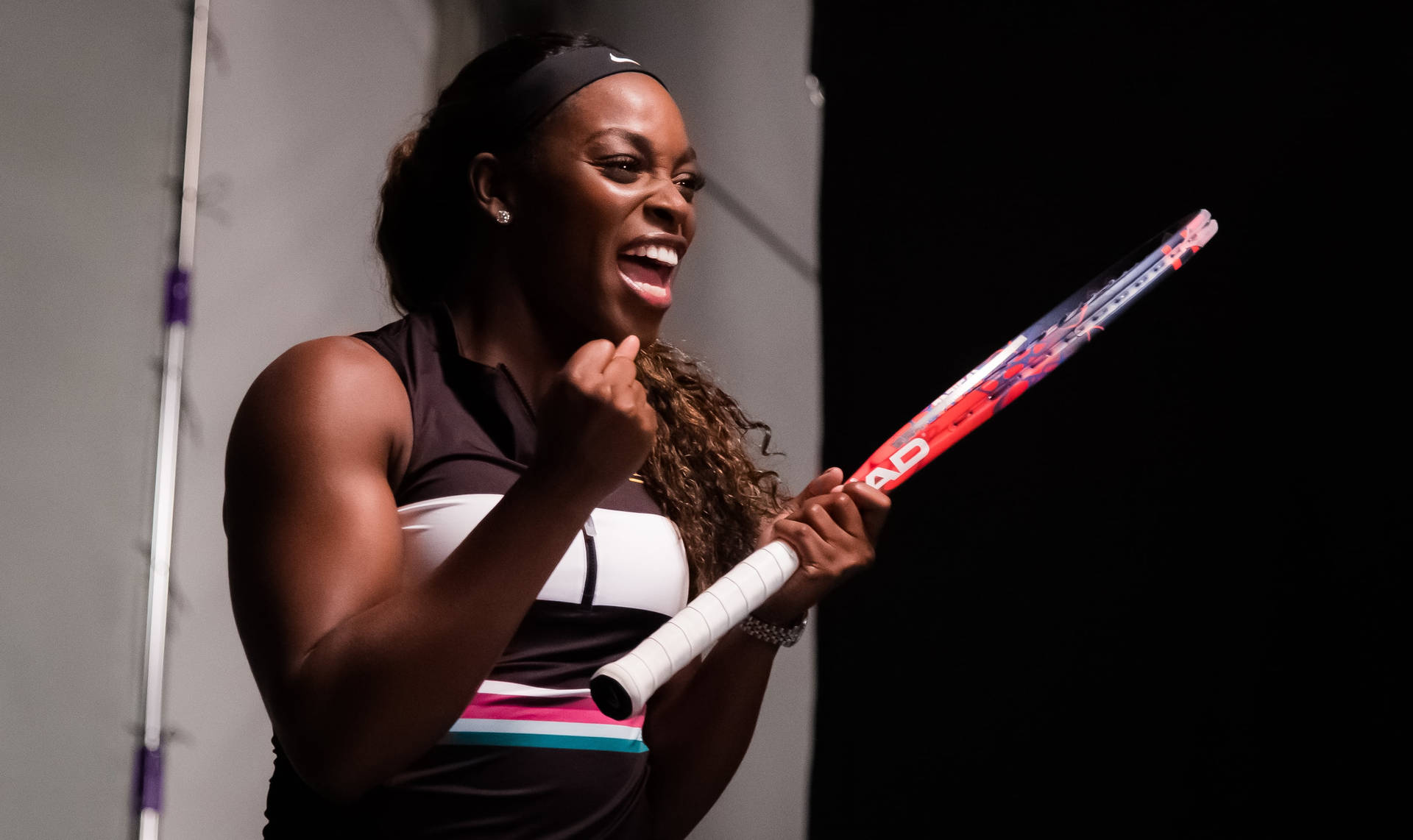 Happy Sloane Stephens Holding A Racket Background