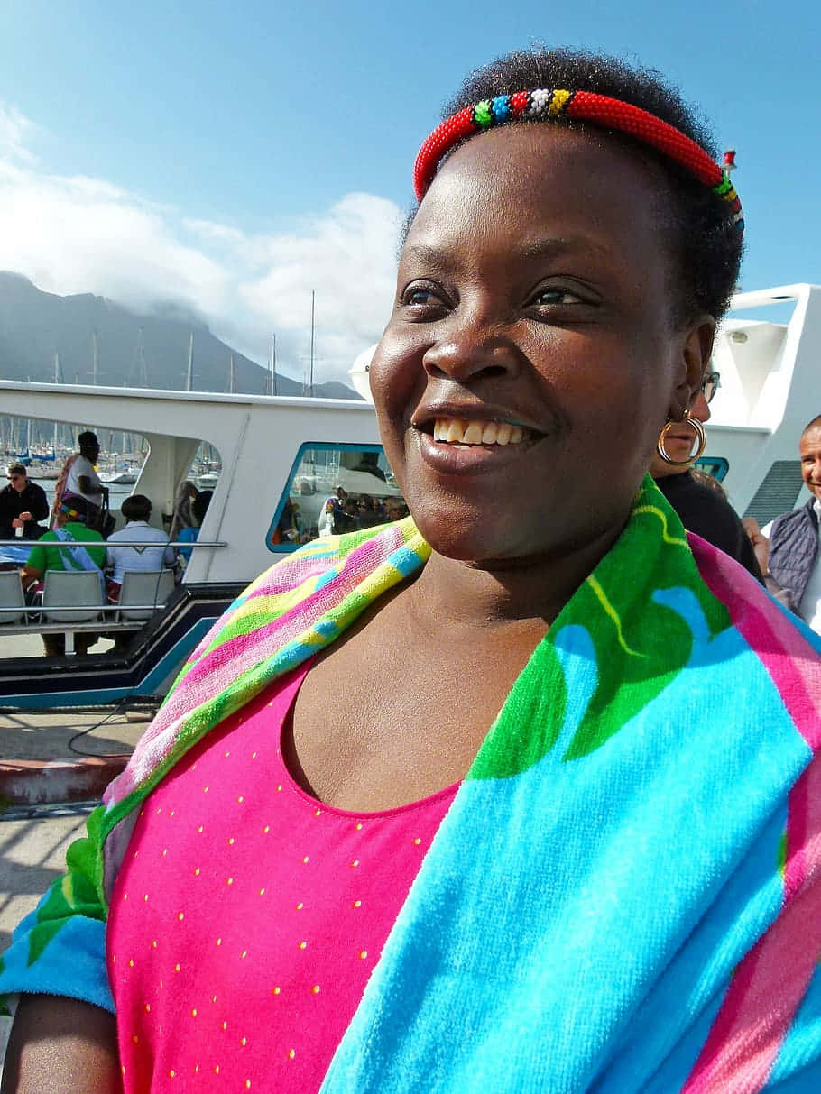 Happy South African Woman With Colorful Scarf Background