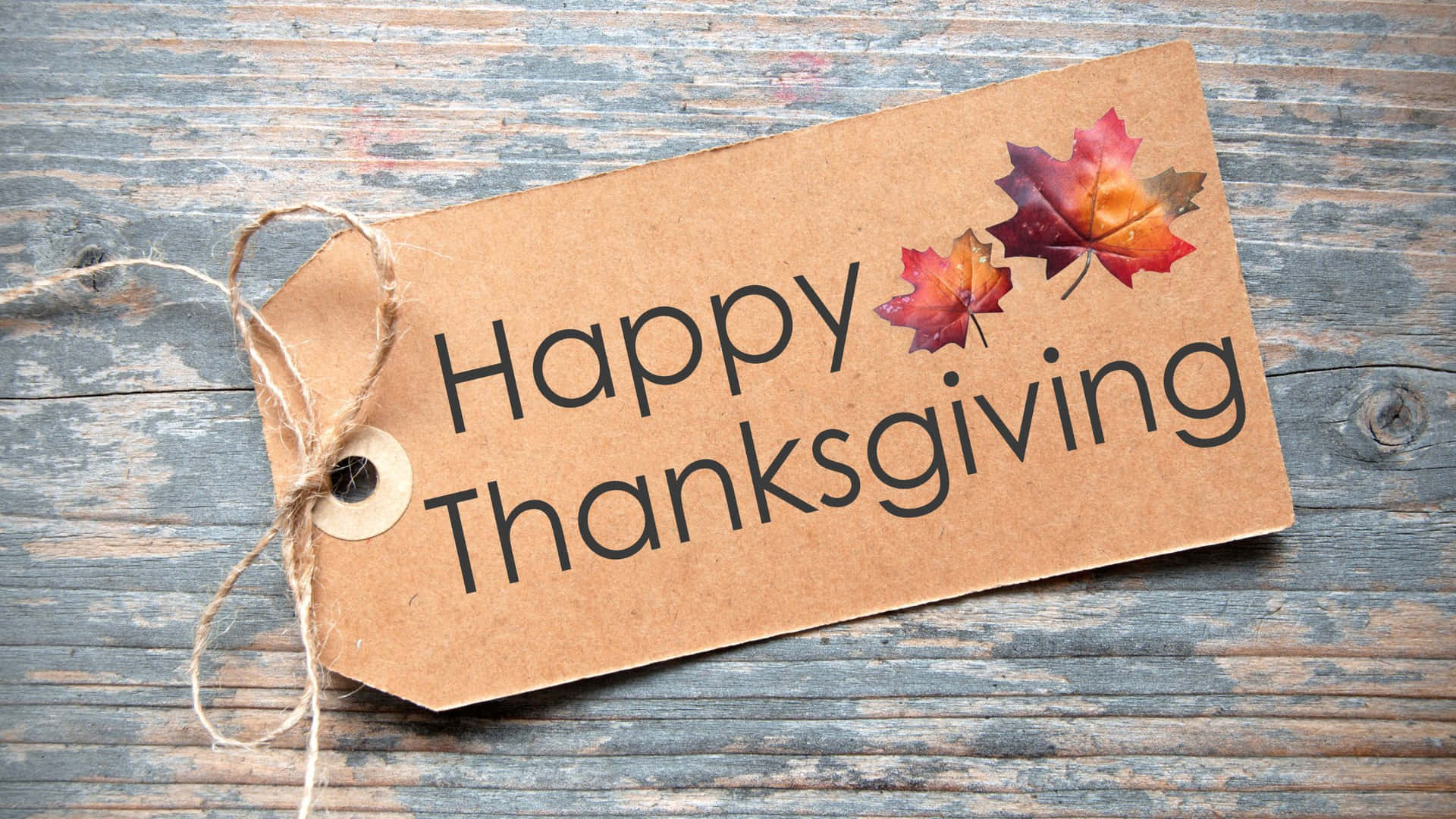 Happy Thanksgiving Tag With Leaves On A Wooden Background Background