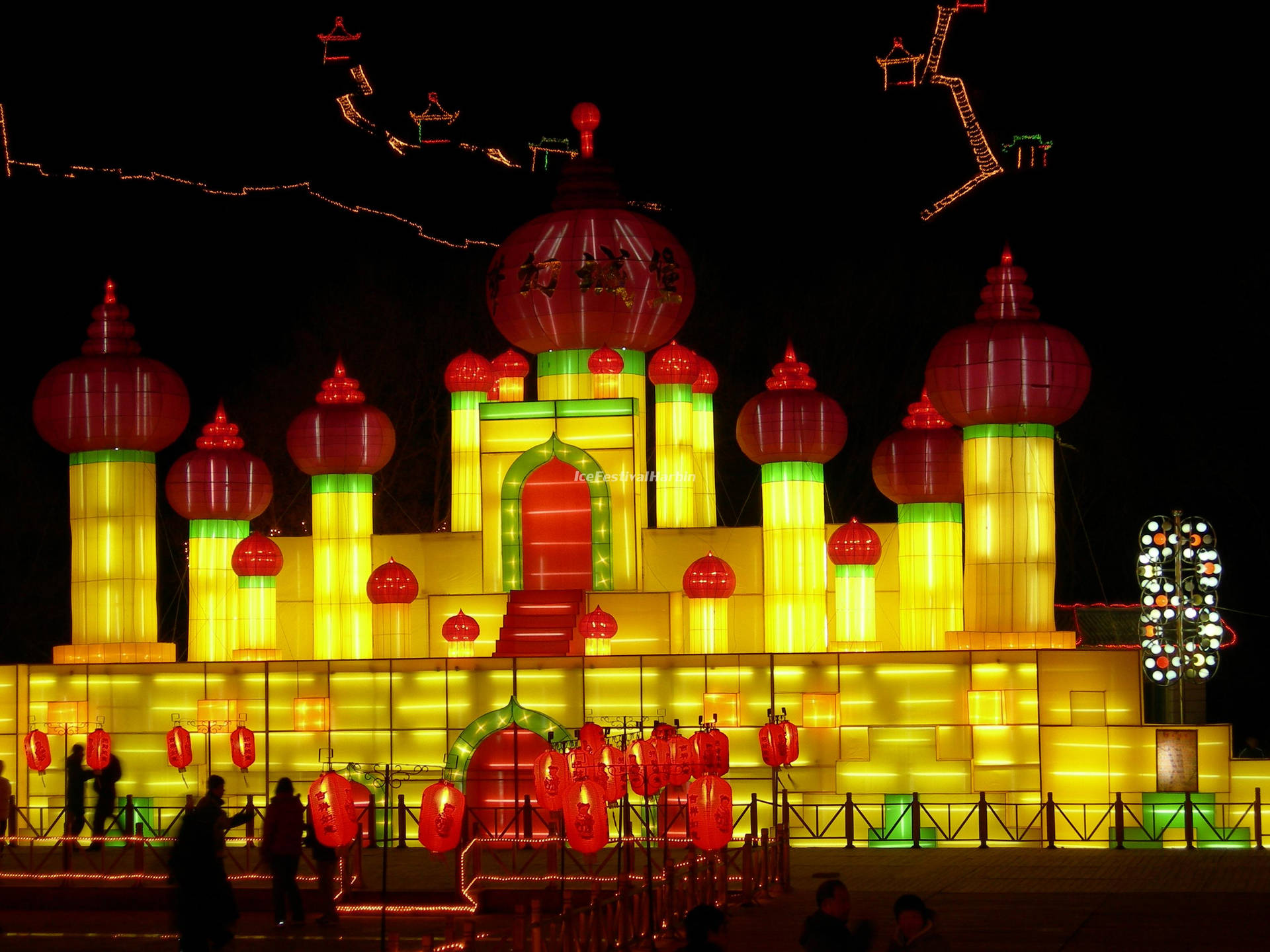 Harbin's Dazzling Ice Palace Aglow At Night Background
