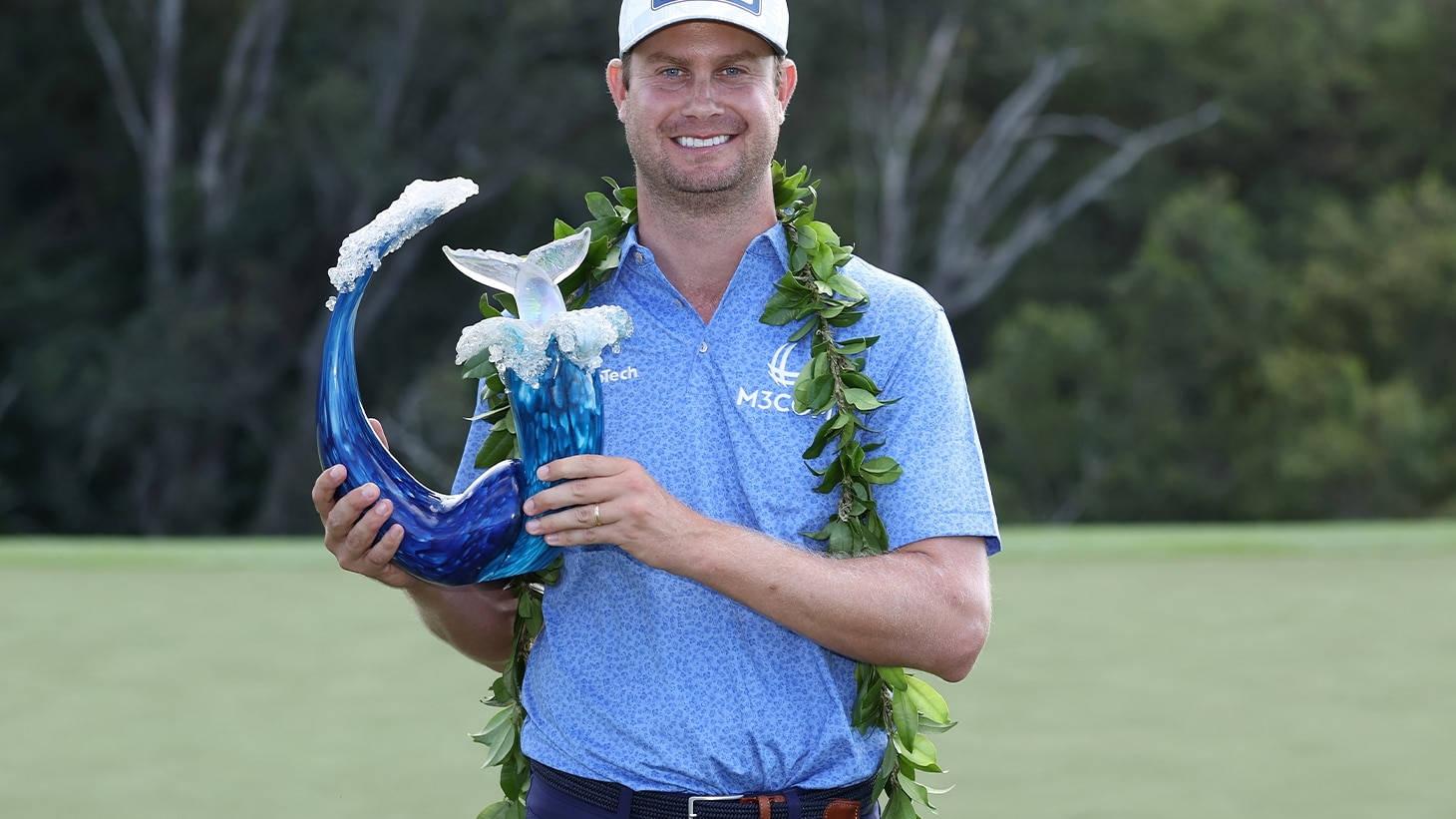 Harris English Holding A Trophy Background