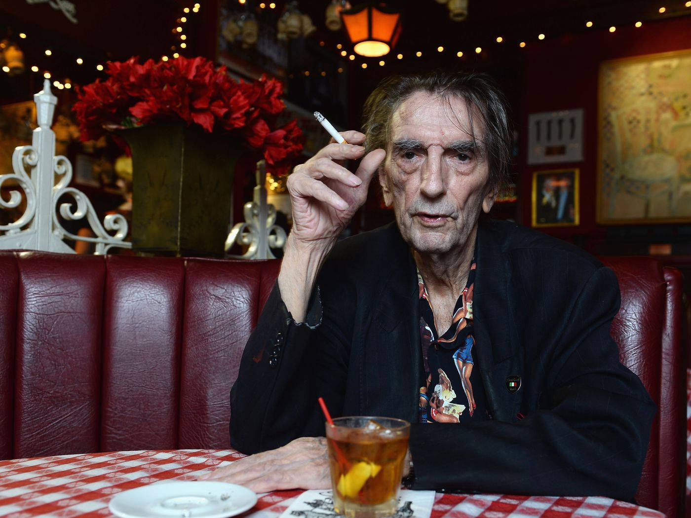 Harry Dean Stanton Smoking Cigarette On Table Background