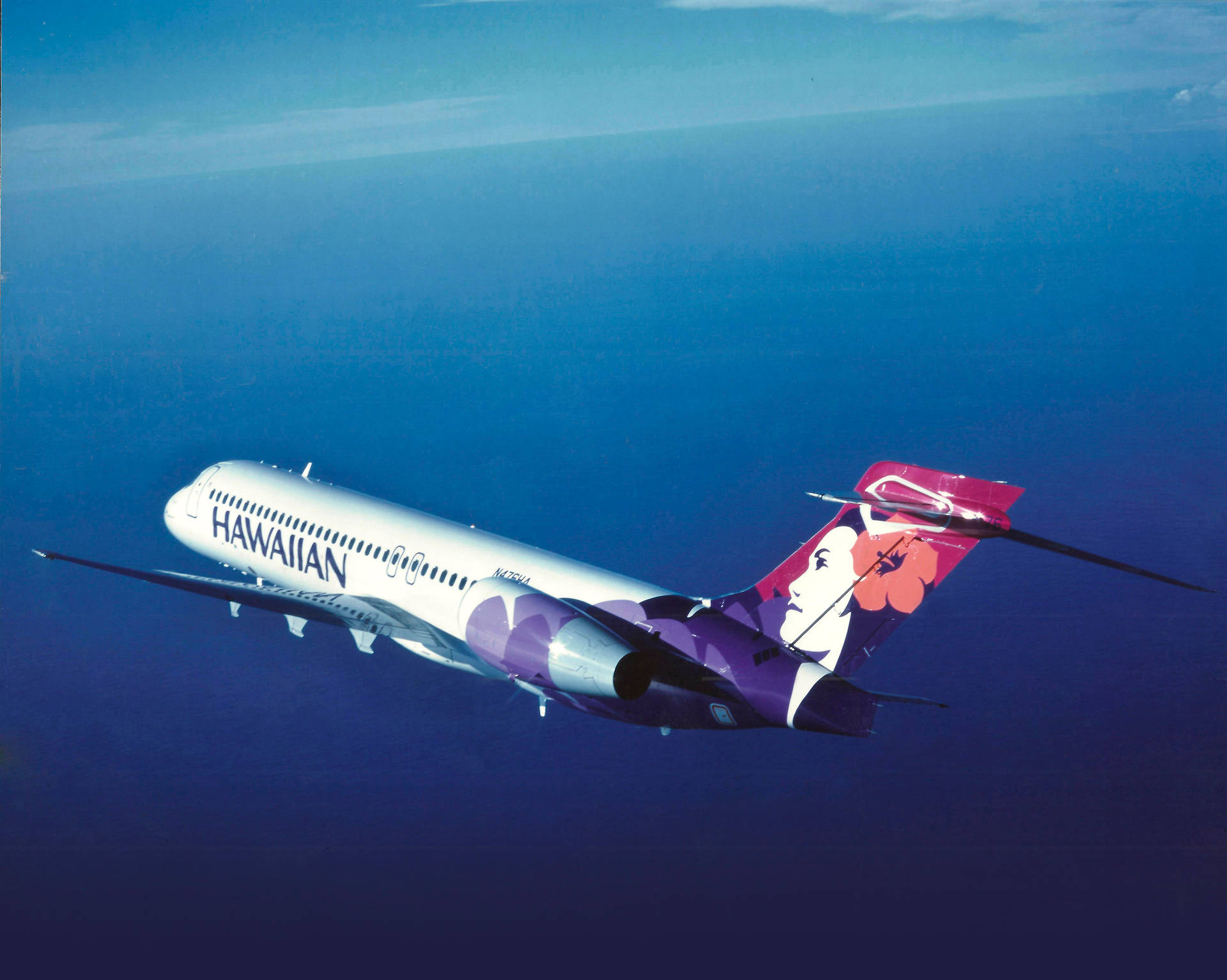 Hawaiian Airlines Plane Above The Ocean Background