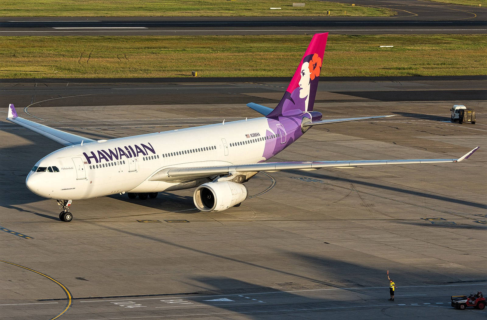 Hawaiian Airlines Plane On The Tarmac Background