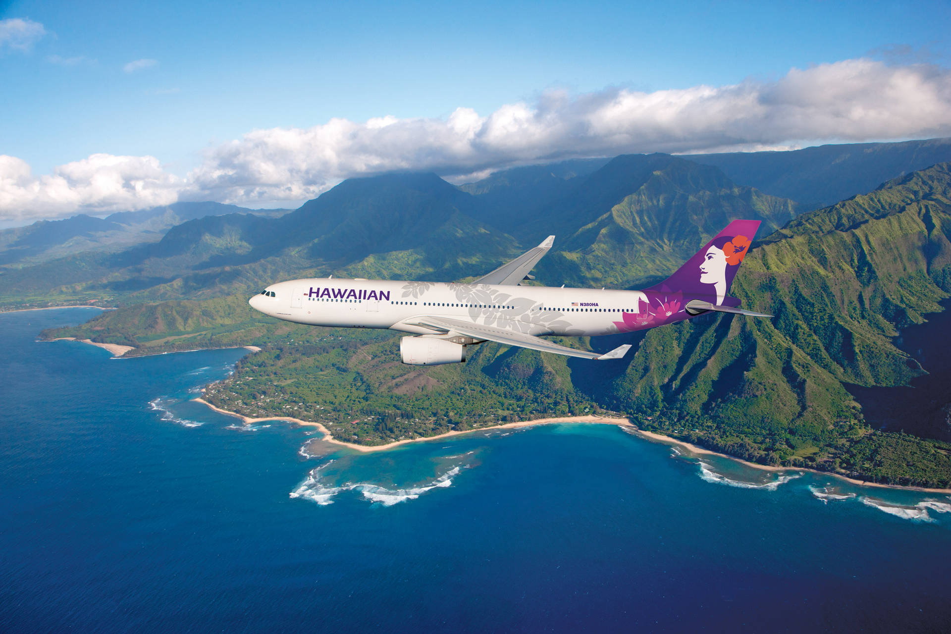 Hawaiian Airlines Plane Over Lush Green Mountains Background