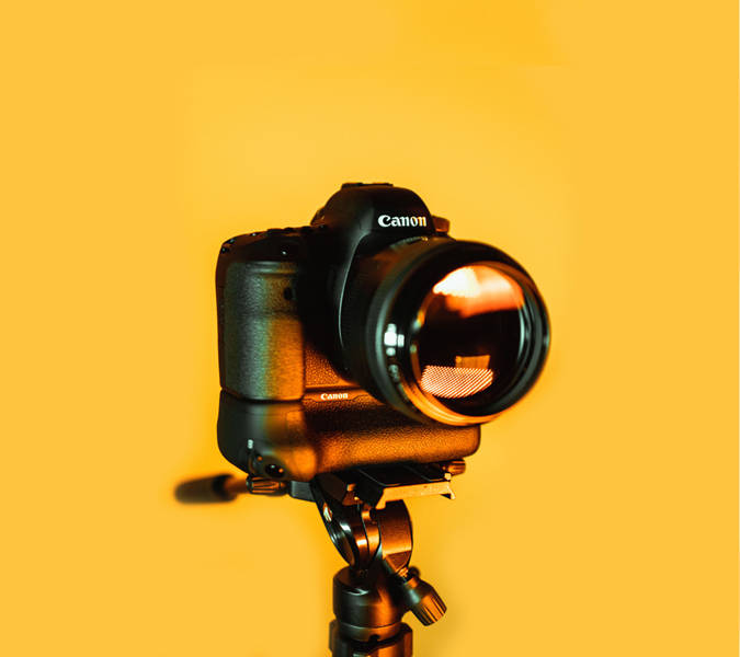 Hd Photography Of A Camera On Yellow Backdrop